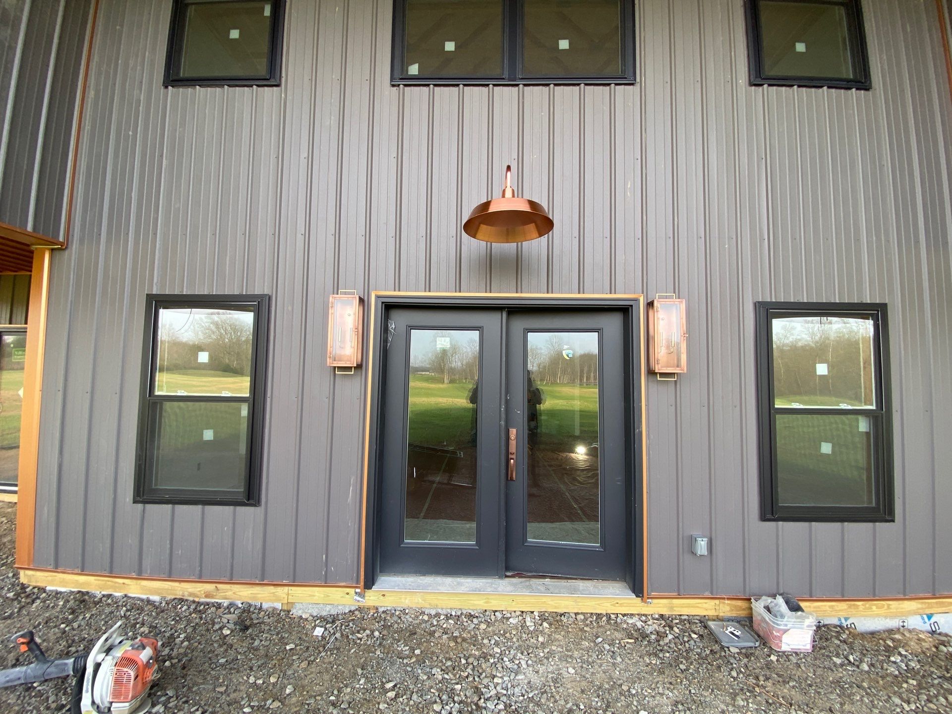 Custom Pole Barn Home with Charcoal Siding and Copper Roof by The Barn Builders