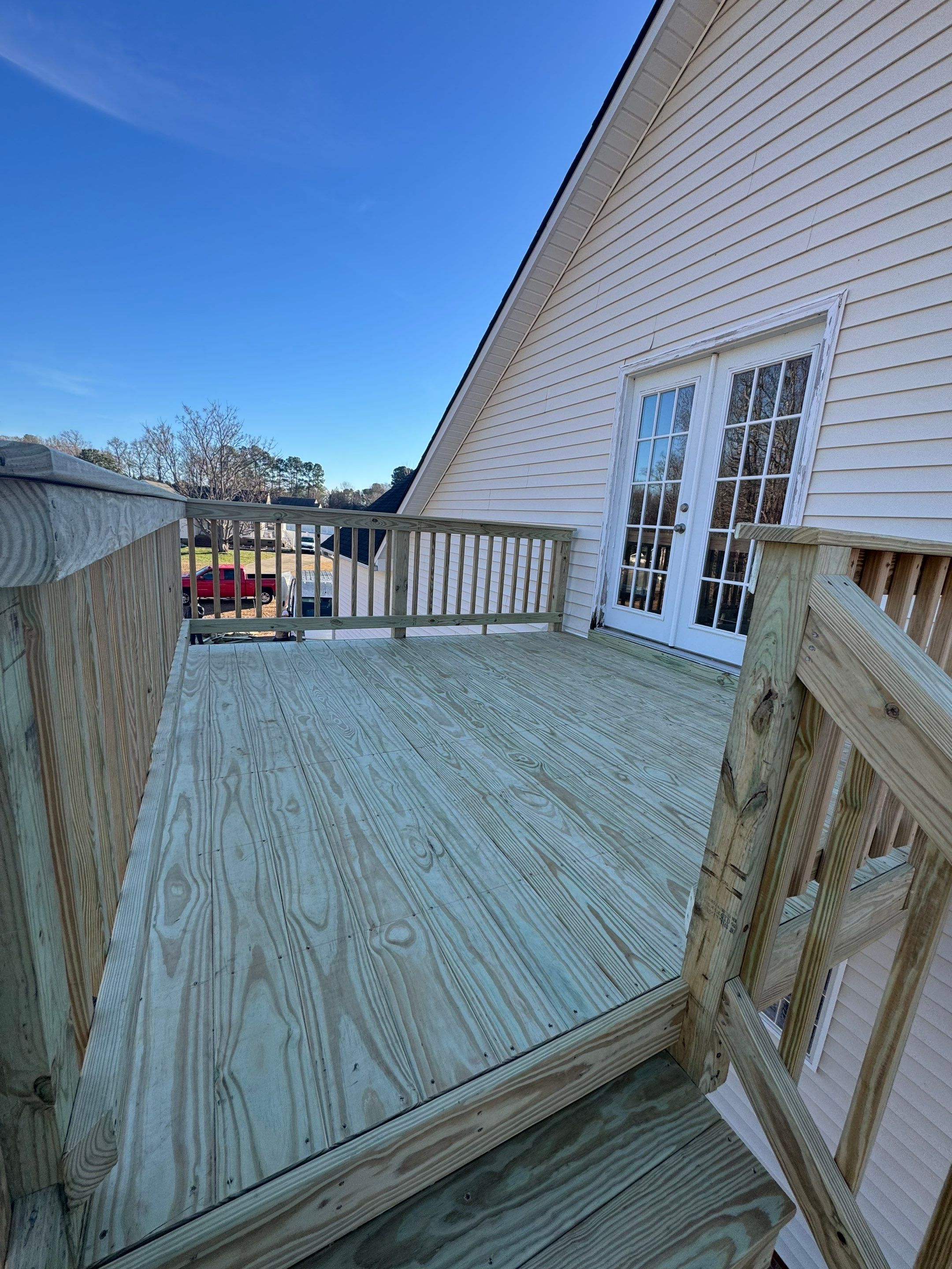 Elevated Pressure-Treated Wood Deck and Sliding Glass Door Installation in Clayton by The Remodeling Company
