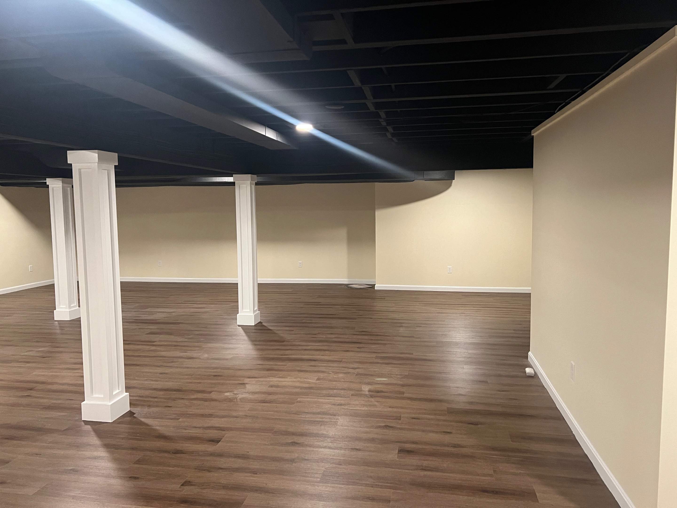 Basement Remodel w/ LVP Flooring & Exposed Ceiling by Chagnon Building & Remodeling LLC