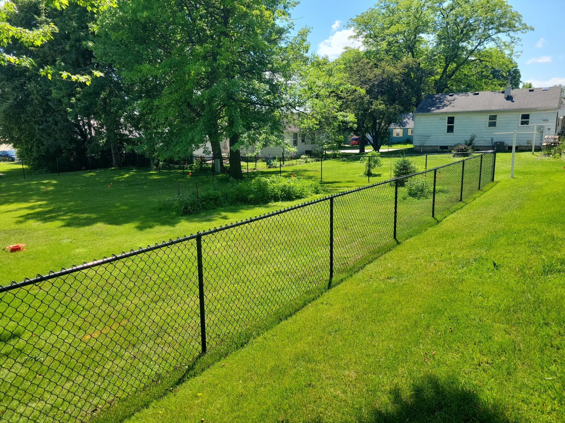 Black Chain Link Perimeter Fence and Driveway Gate in Waverly by Perfect Picket Fence and Stain