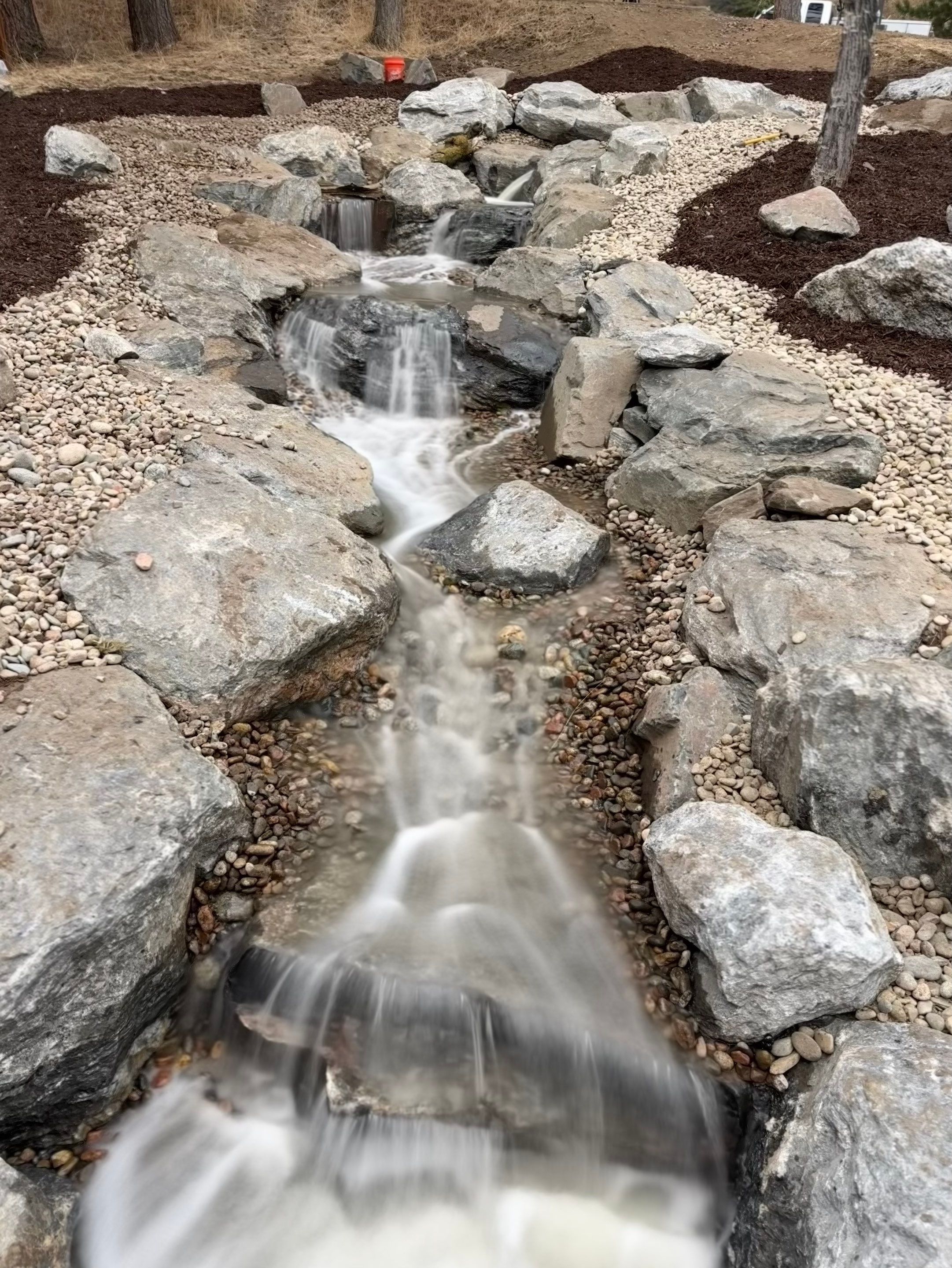 large waterfall and deck by JRM landscape & design