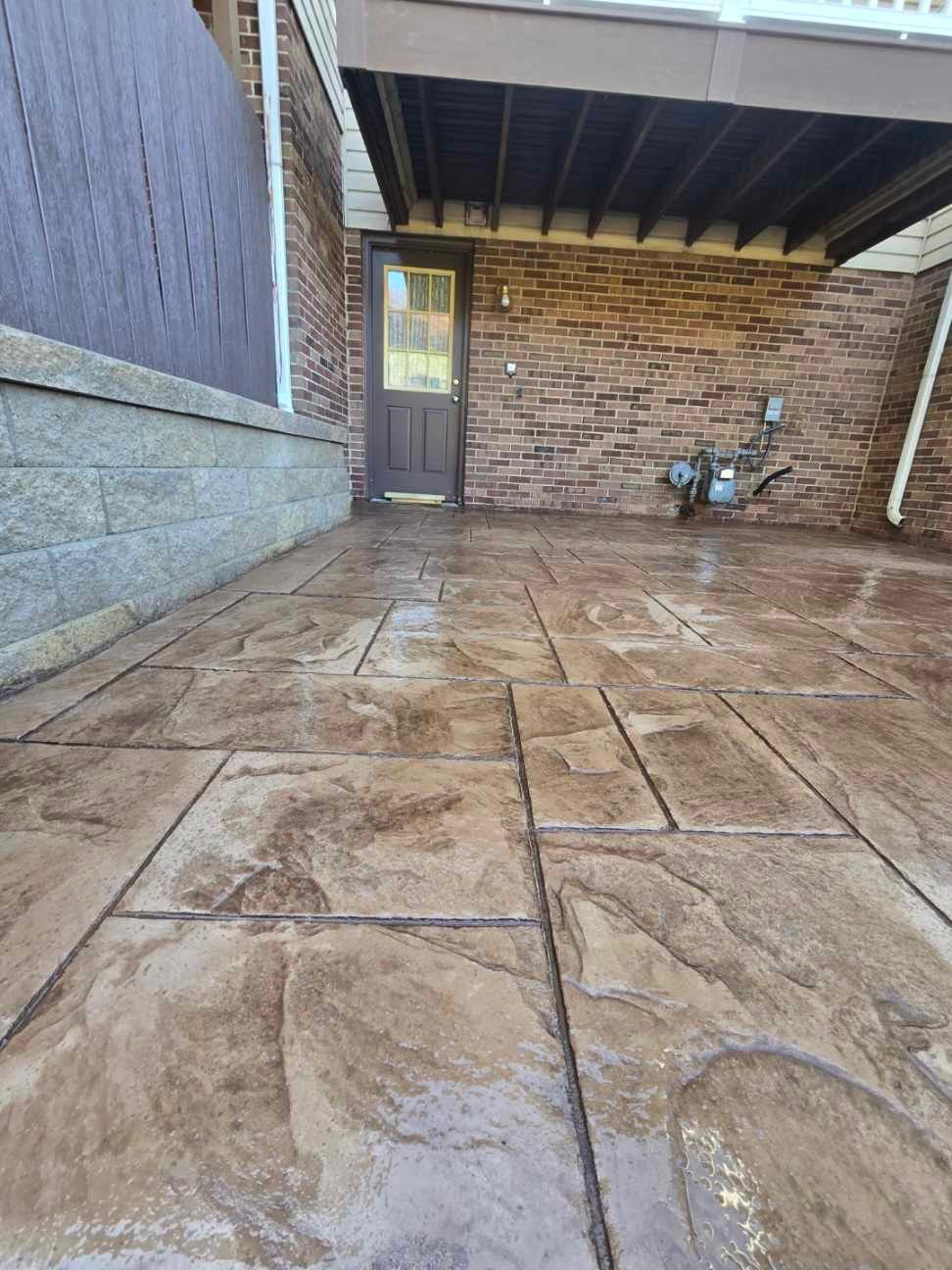 Stamped concrete and redeck  by Cousins Roofing Siding & Decks