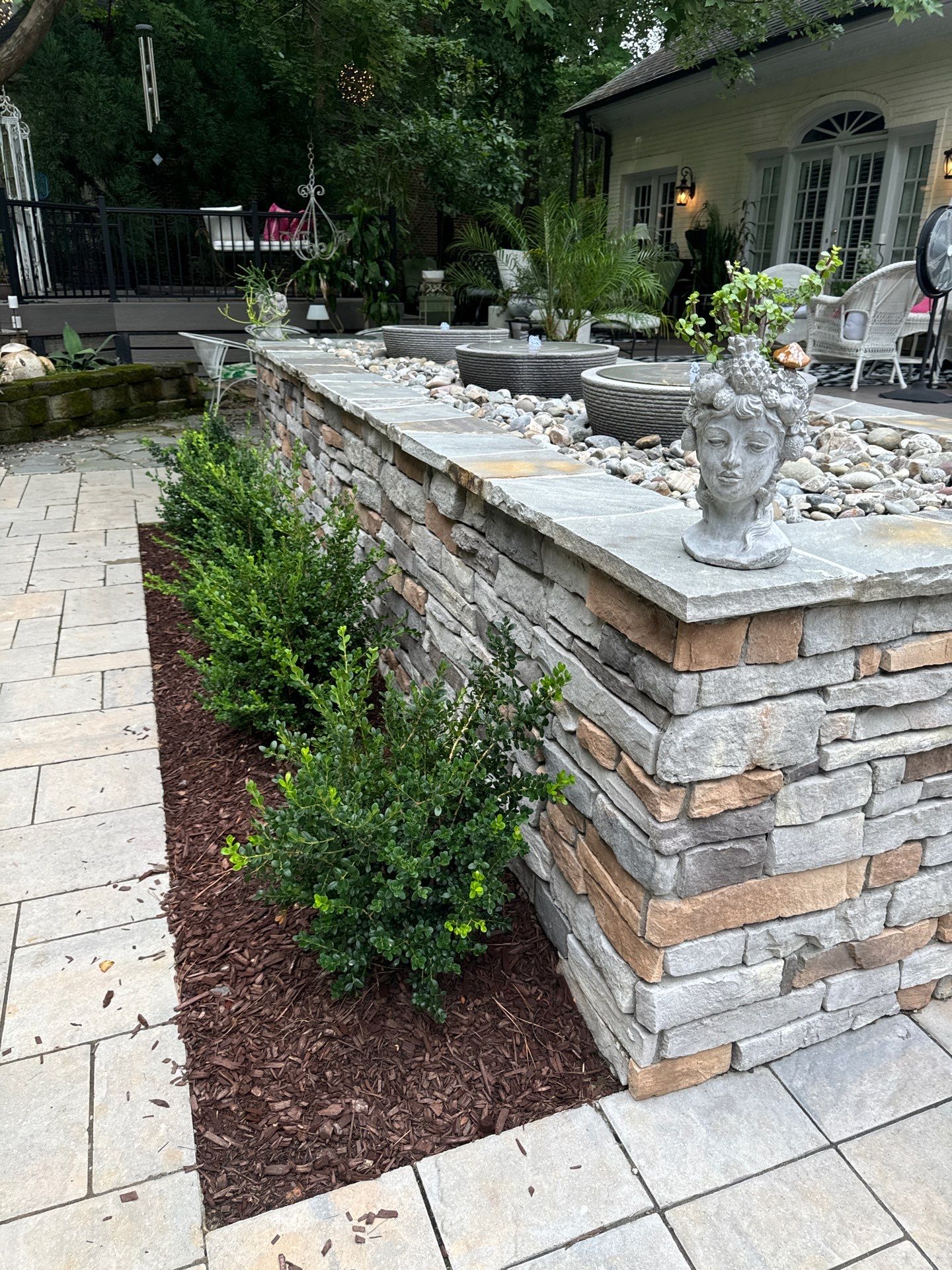 New Deck, Stone Fountain Feature, Circle Stone Sitting Area with Fireplace by The Remodeling Company