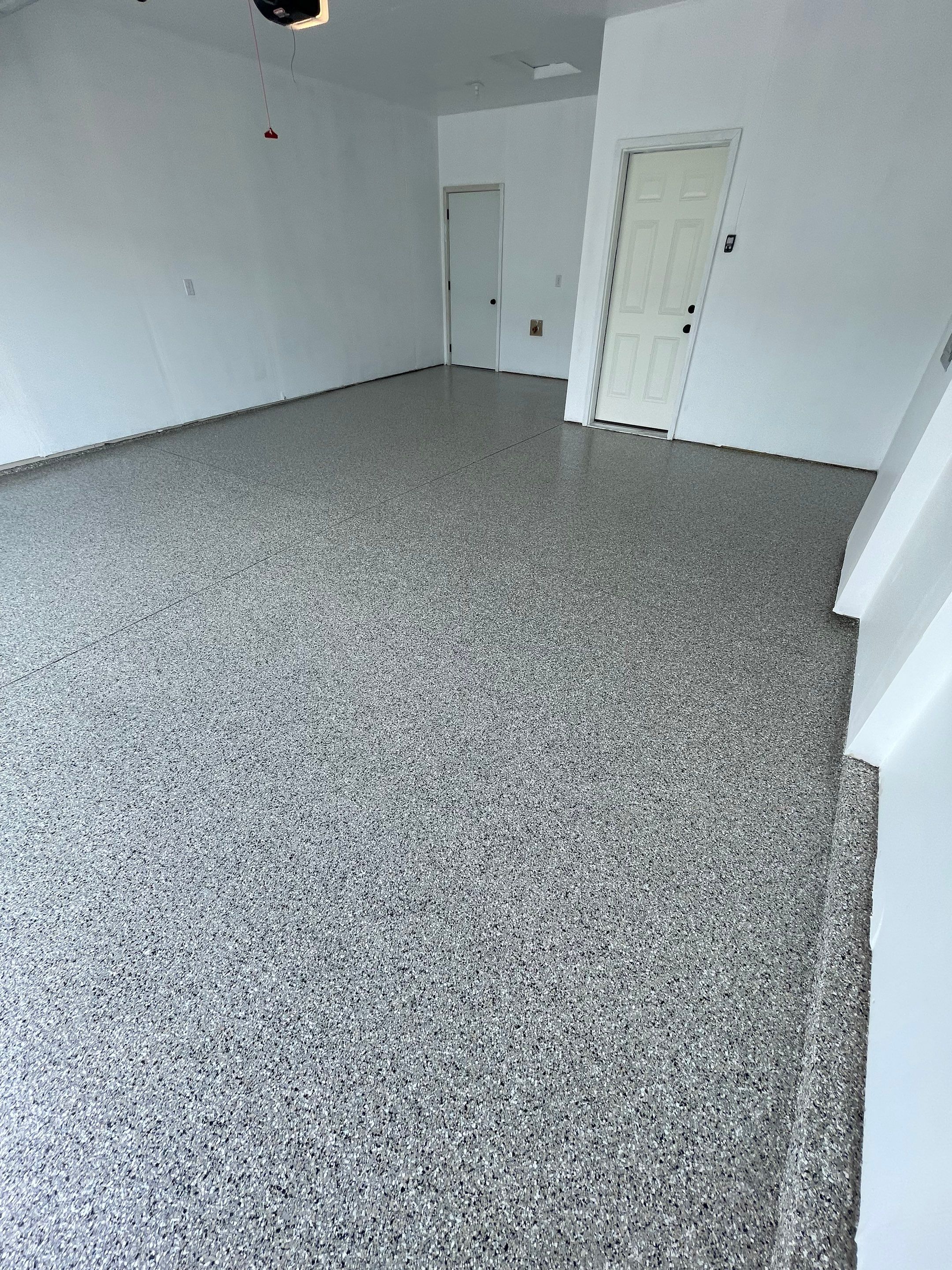 Sioux Falls Garage Floor Transformation with Cabin Fever Decorative Chips by Select Painting, Coatings & Garage Cabinets