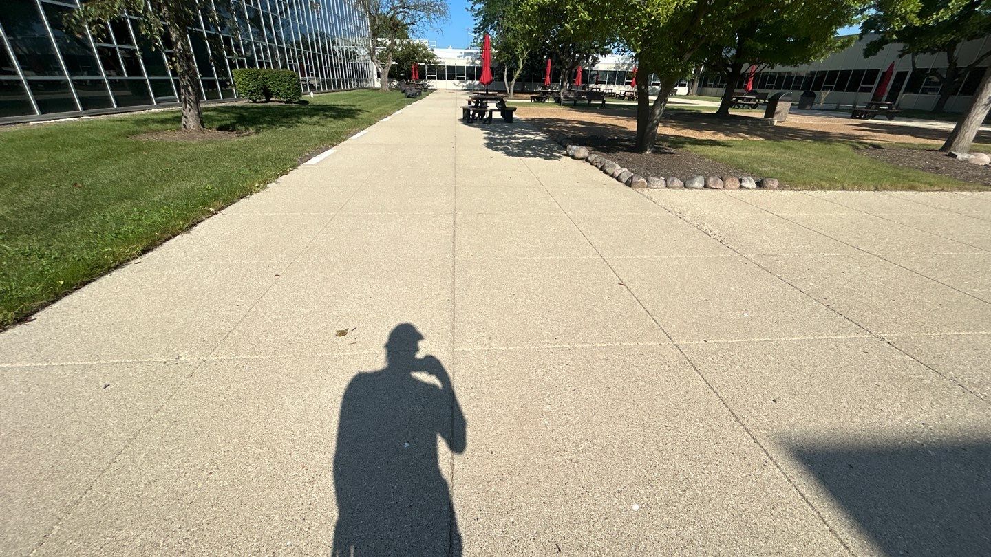 concrete using Algaecide, soft wash soap by Northern Power Washing LLC.