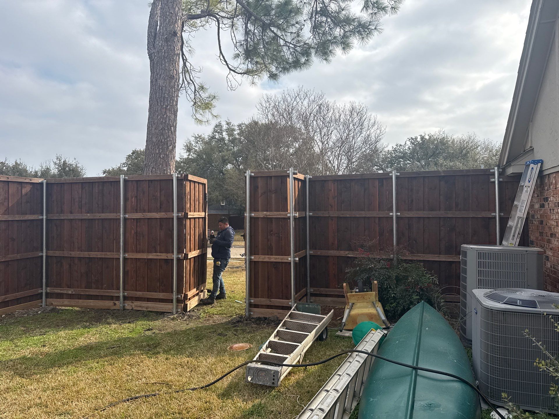 Pre-Stained board on board w/ trim and kickboard using 1x4 cedar trim by Grizzly Fence And Patio