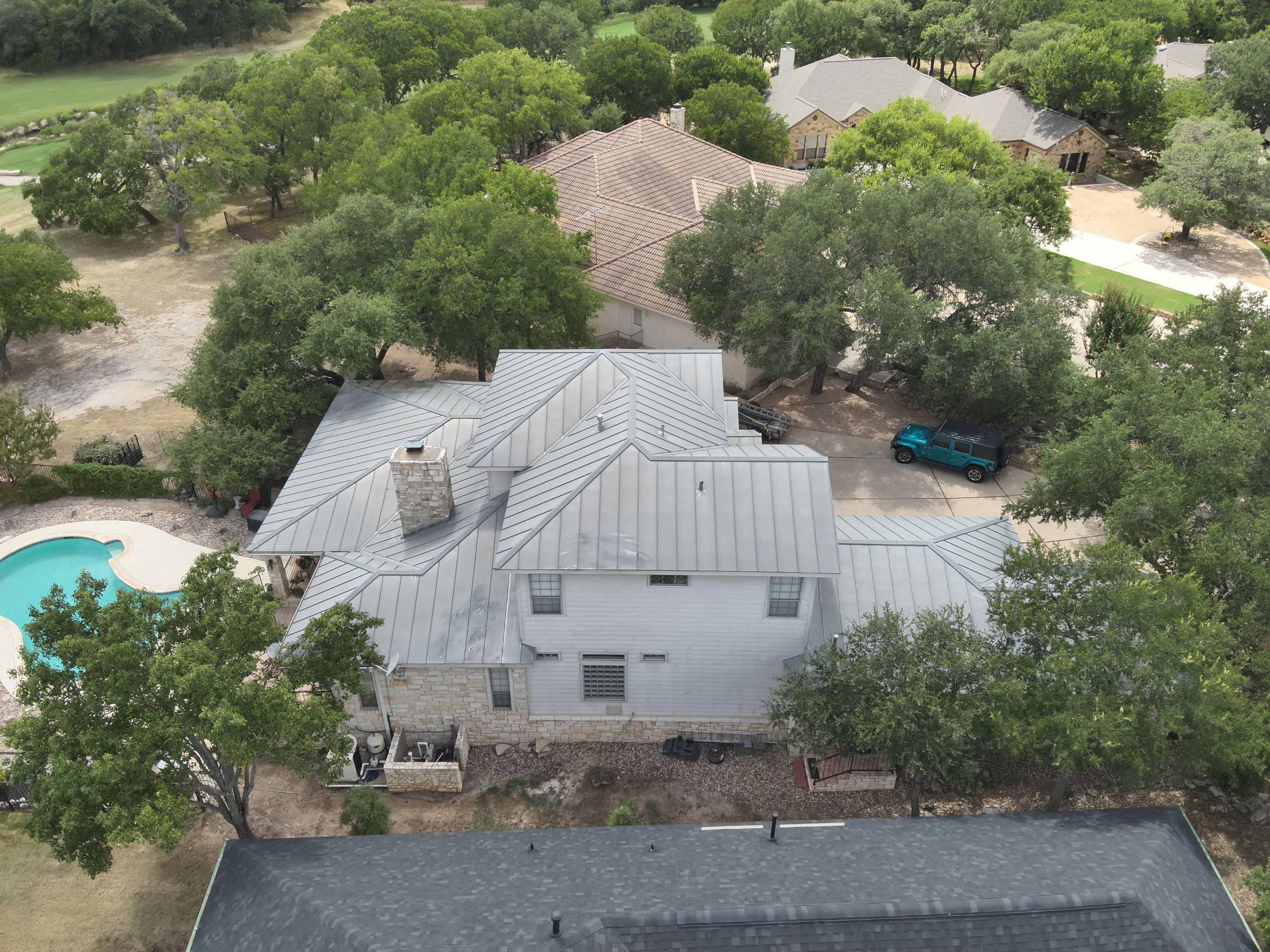 Residential Roof Replacement using 24 GA Double-Lock - Surrey Beige by Action Exteriors Austin