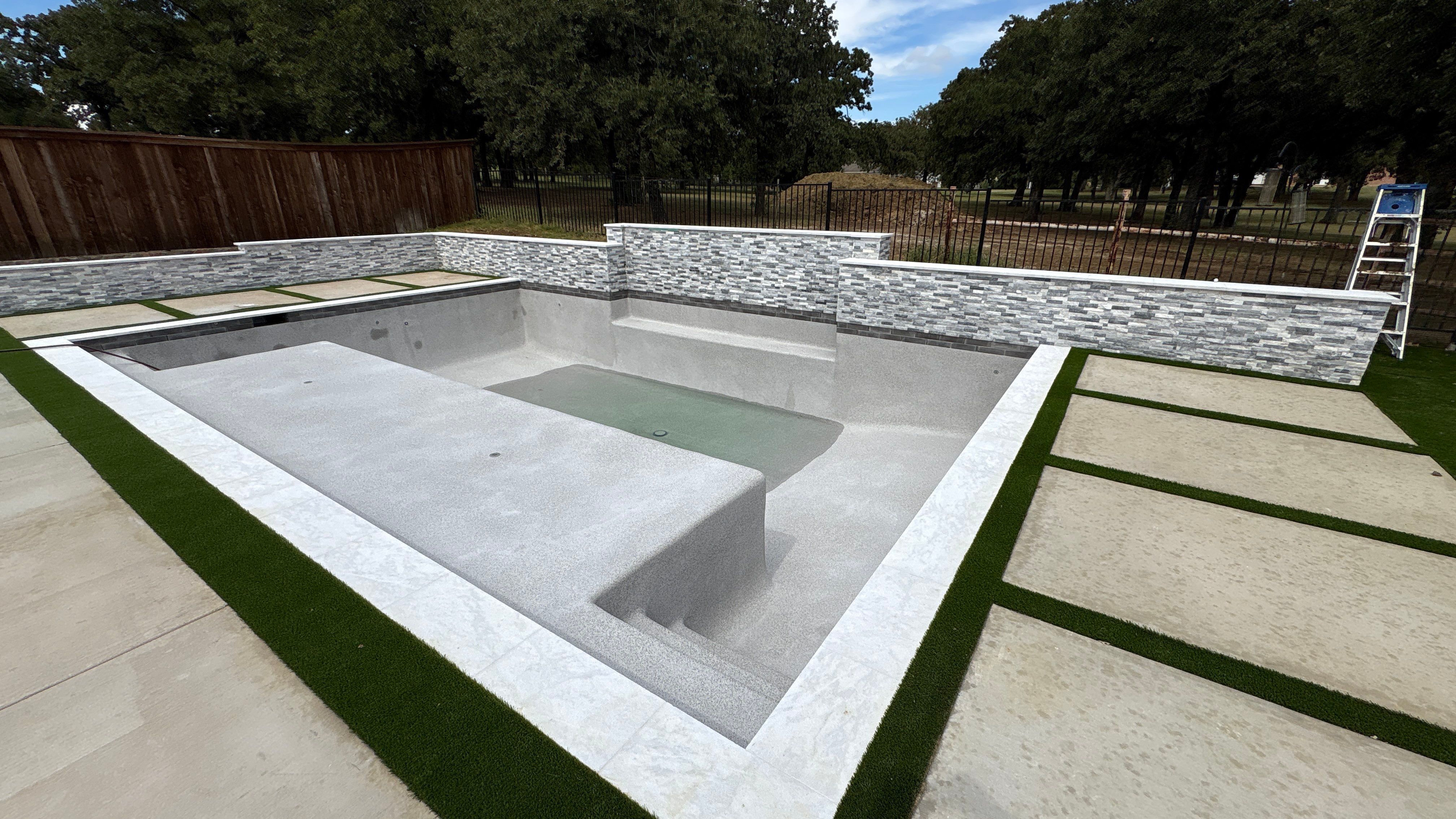 Geometric Pool with Stacked Stone Water Wall by Pinnacle Pools and Spas - DFW