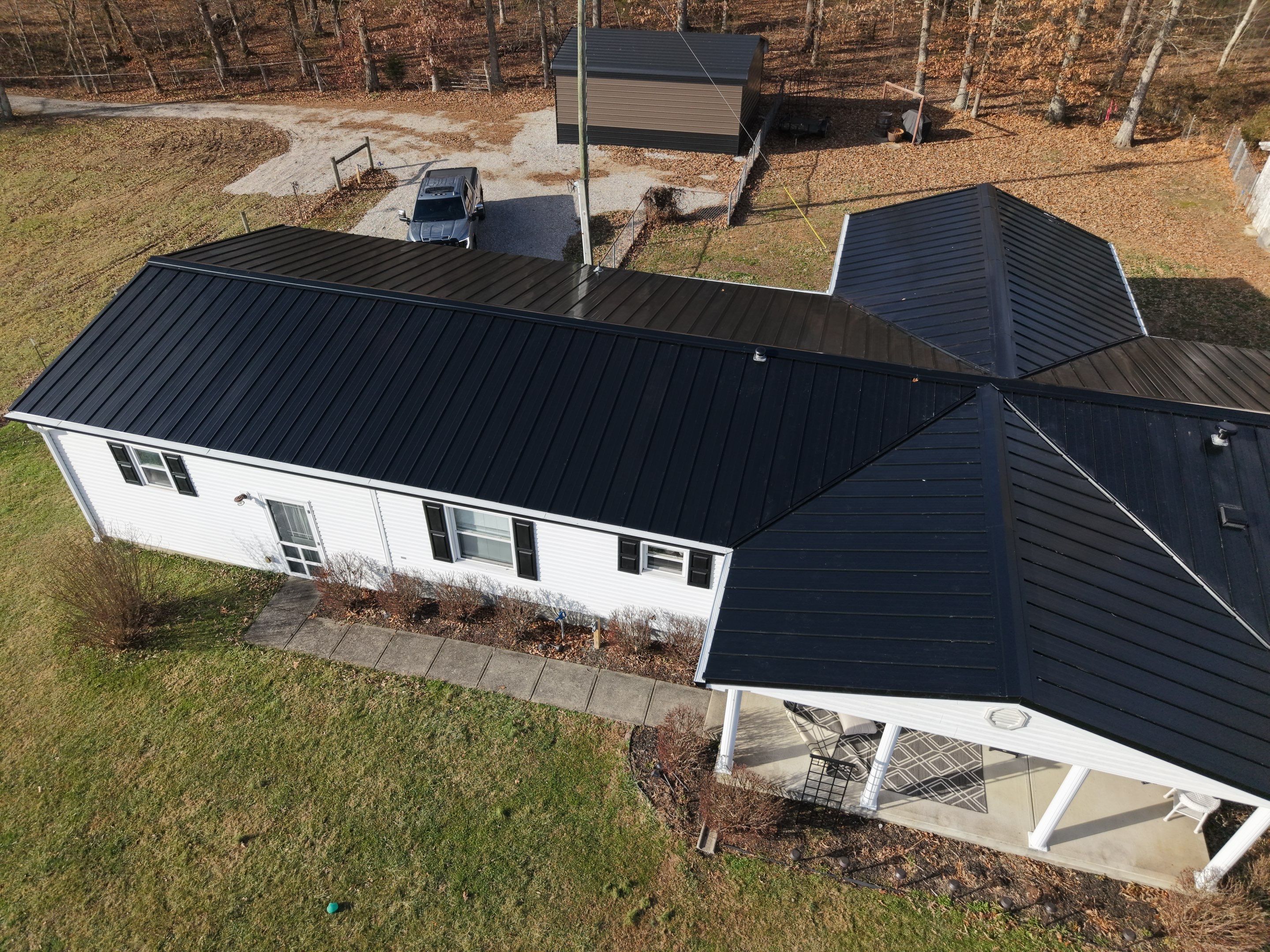 Standing Seam Roof & Black Gutters by Stout Exteriors
