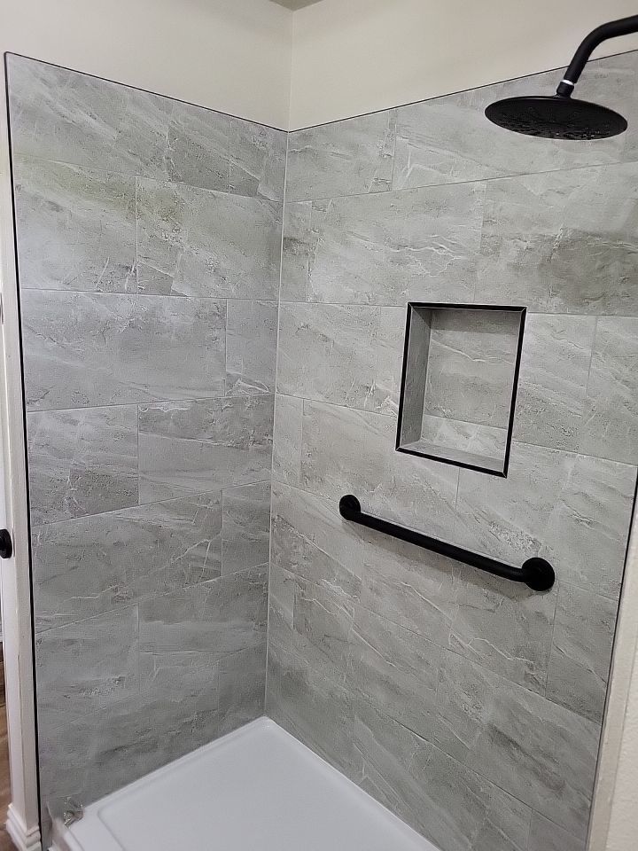 Bathroom Remodel using Tile  by SLM General Contractors & Roofing