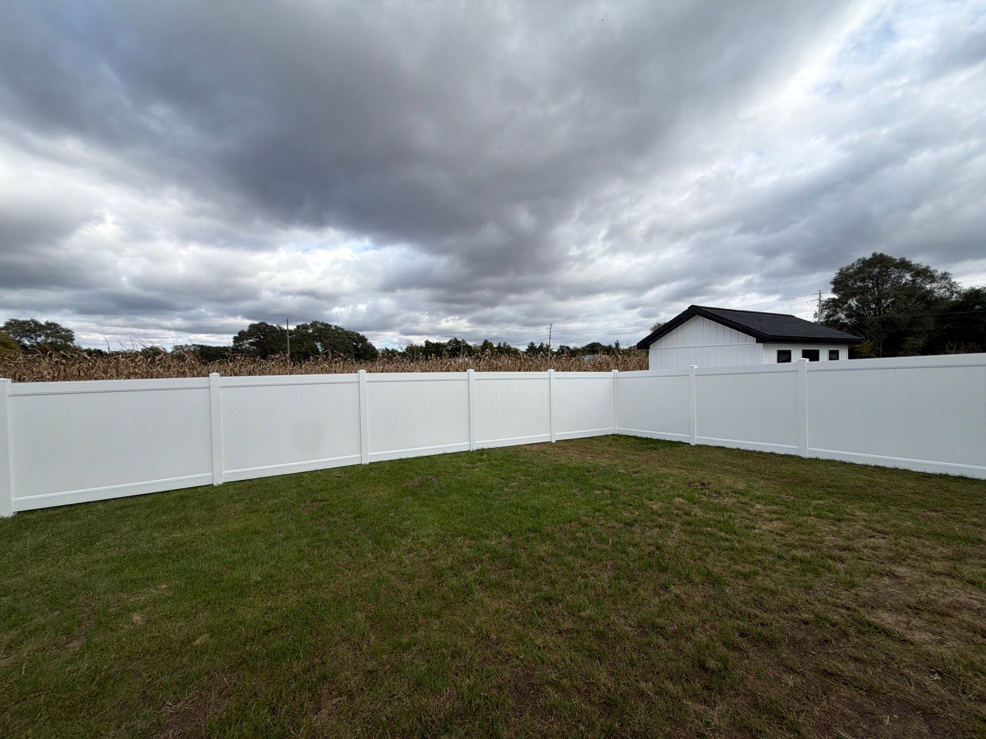 Residential White Vinyl Privacy Fence Installation in Janesville by Perfect Picket Fence and Stain