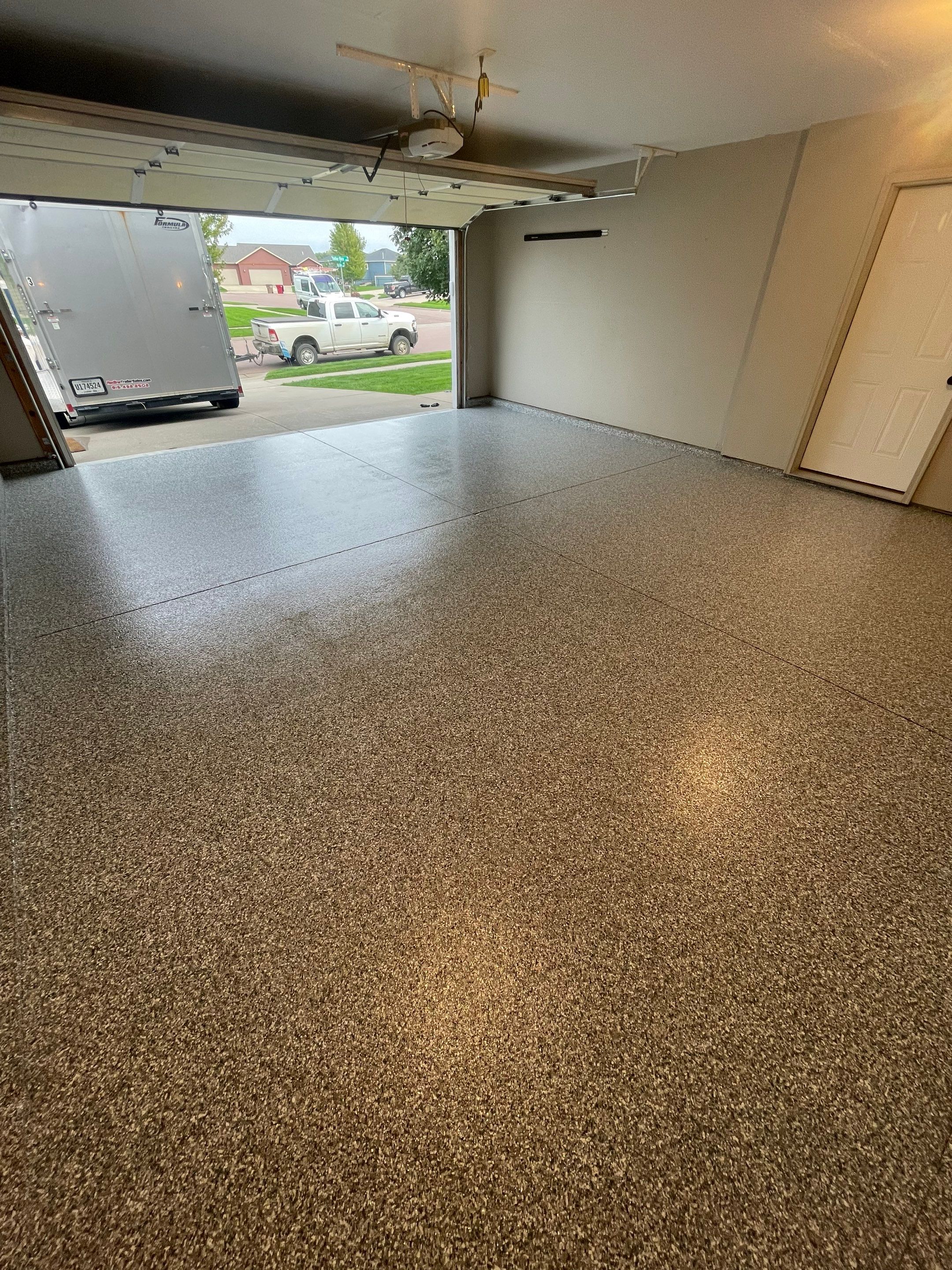 Custom Polyurea Flake Garage Floor Installation in Sioux Falls by Select Painting, Coatings & Garage Cabinets
