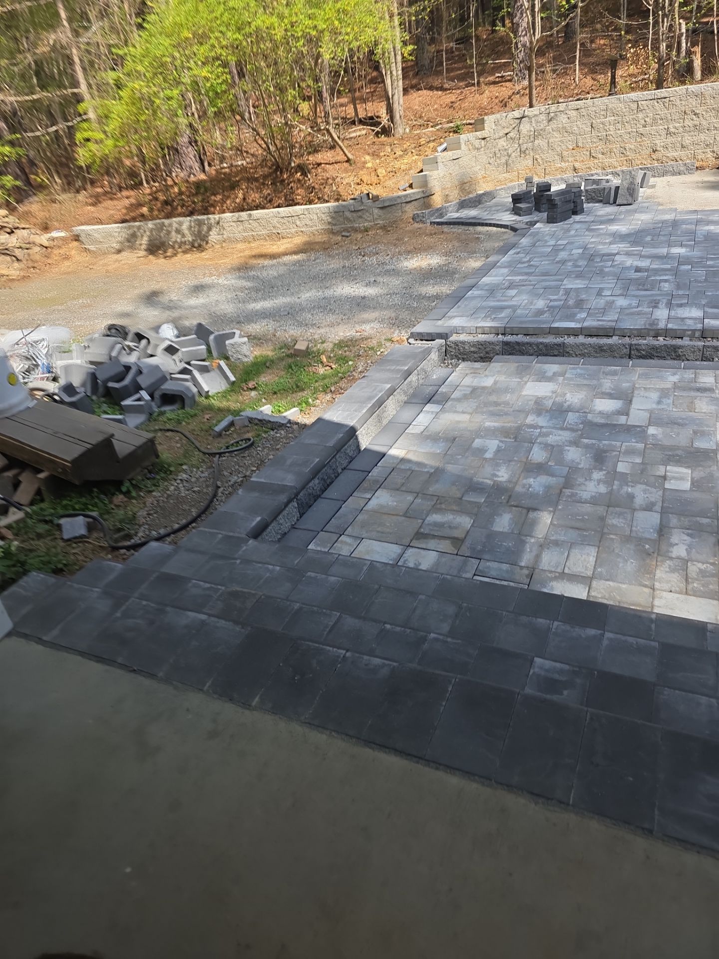 Pittsboro Outdoor Living Transformation – Retaining Wall, Paver Patio & Elevated Deck by Elite Remodeling and Design LLC
