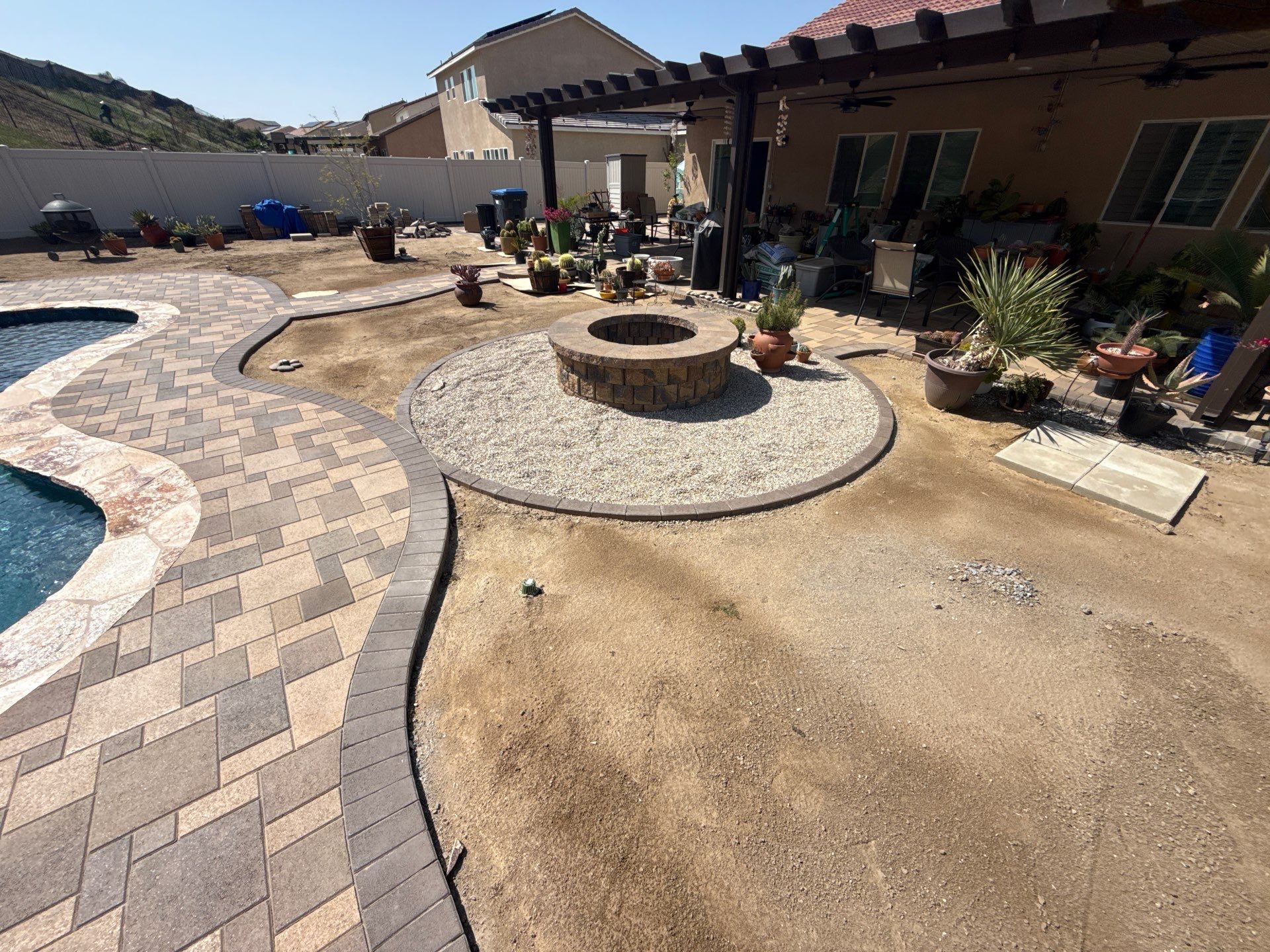 Freeform pool and spa with paver decking by Premier Pools and Spas Temecula