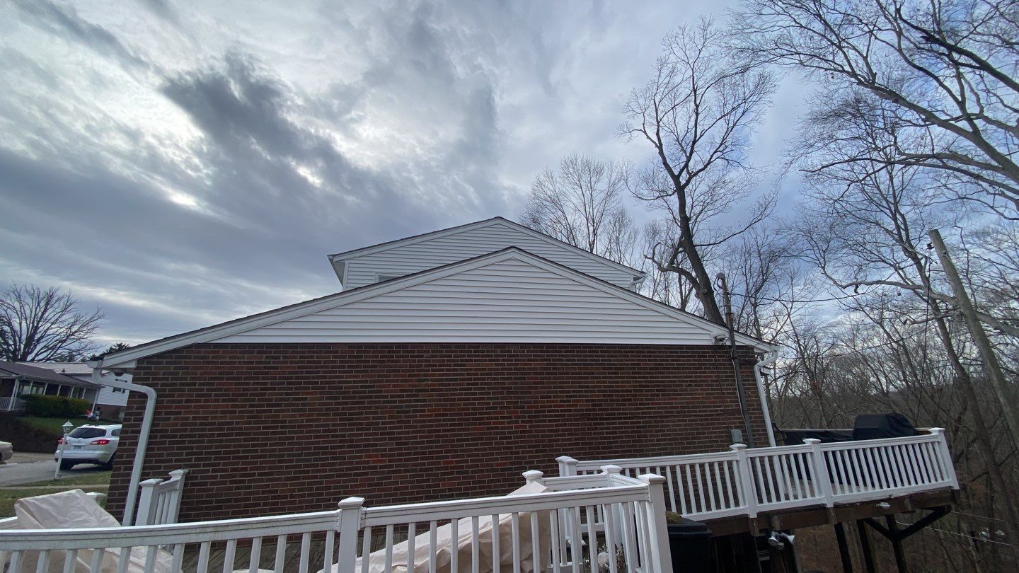 Replace dated vinyl siding with new white exterior Portfolio vinyl siding  by Secure Construction Company Inc