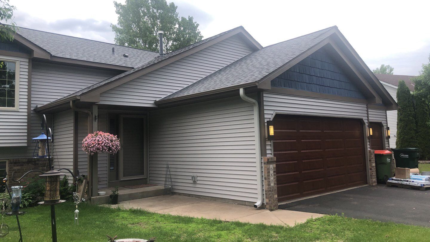 Storm Damage Restoration using Atlas Pinnacle Shingles and Mastic Vinyl Siding  by MODERN EXTERIOR SYSTEMS