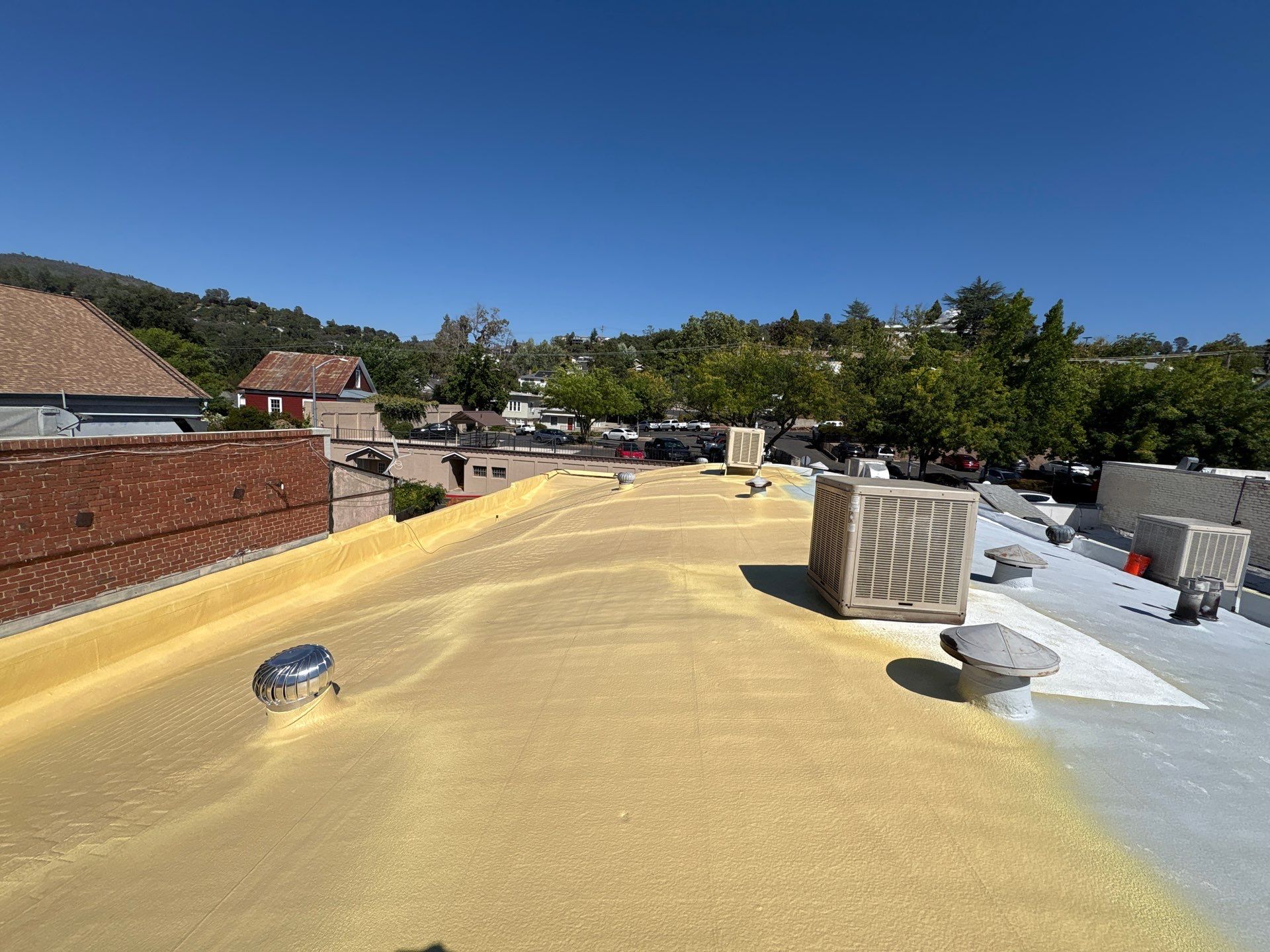 Foam and coatings on commercial roof by Straight Edge Roofing Inc