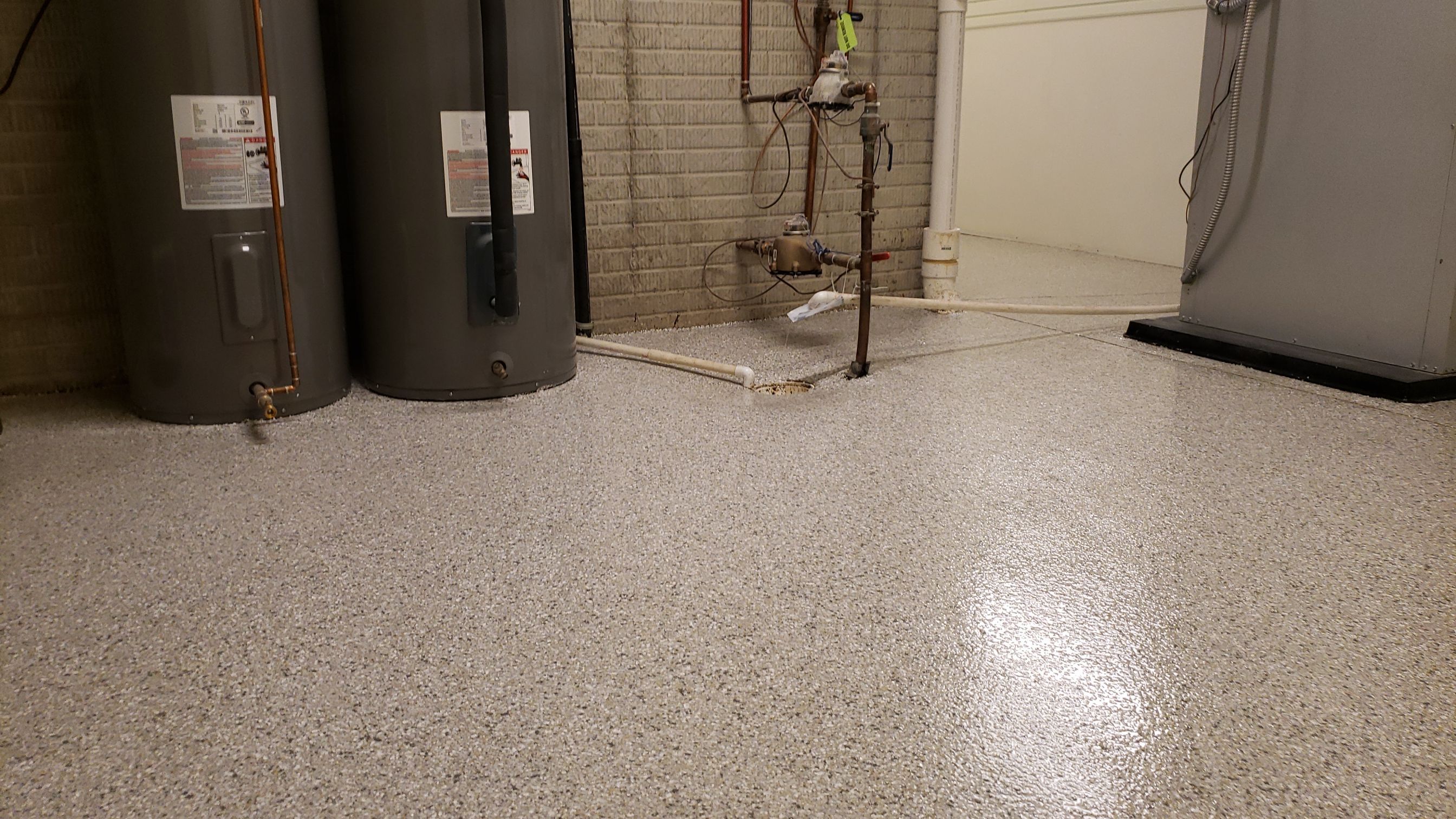 Bright Basement Transformation by Revival Concrete Coatings, LLC