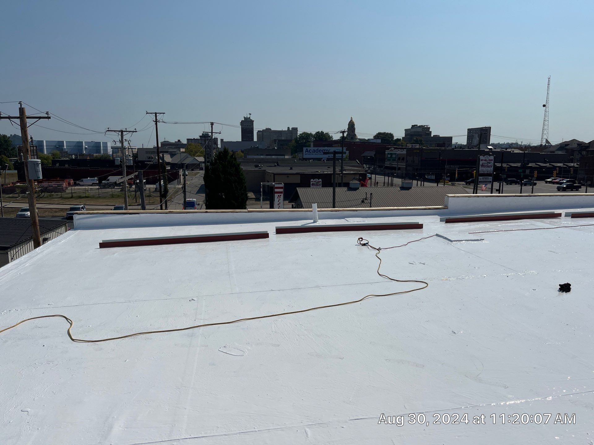 Commercial Roofing Installation using smartcoat Roof coating by Fahey Roofing + Contracting