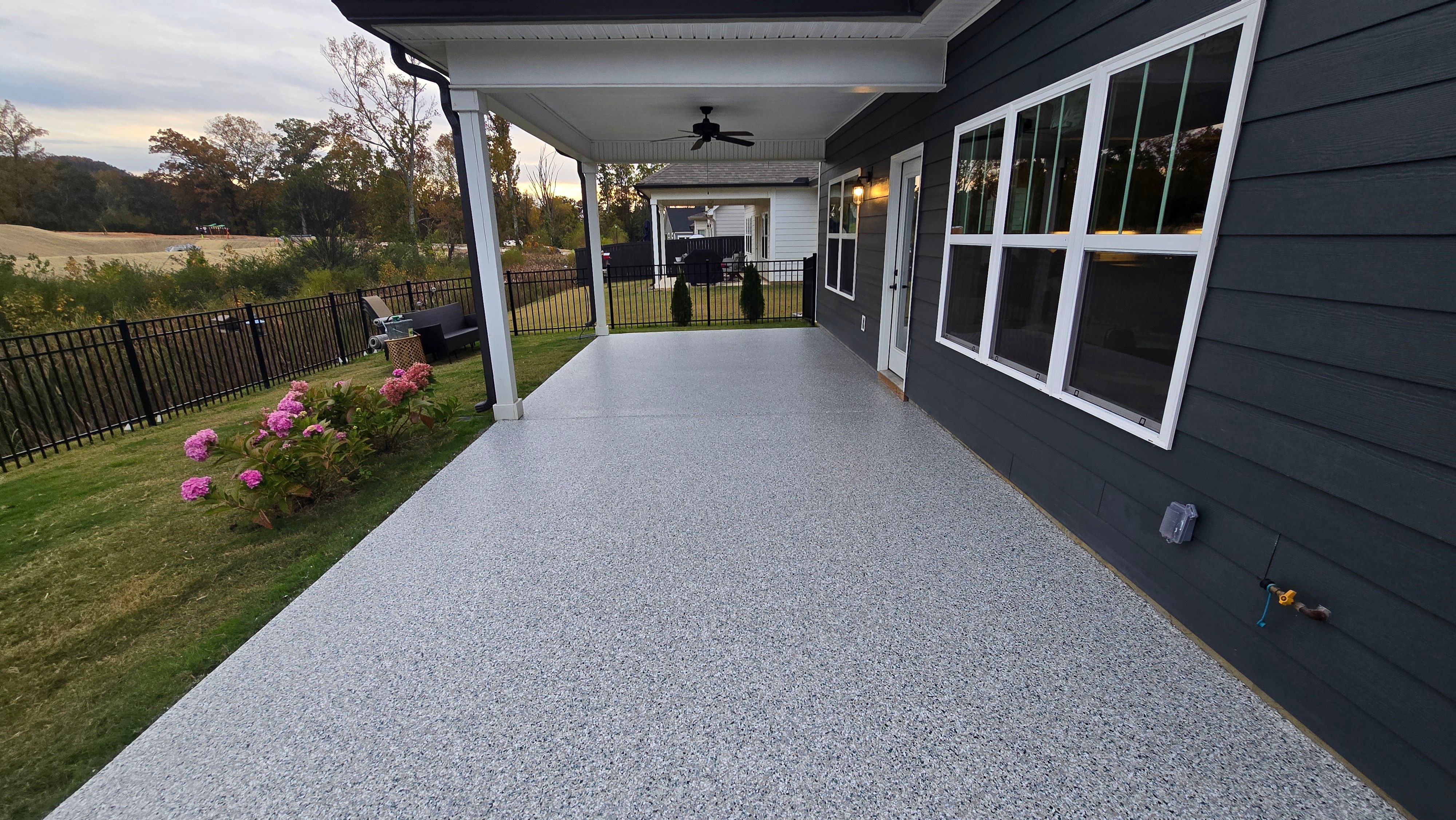Sidewalk, Porch, and Back Patio Using Creekbed and Nordic Green by Elite Floor Solutions