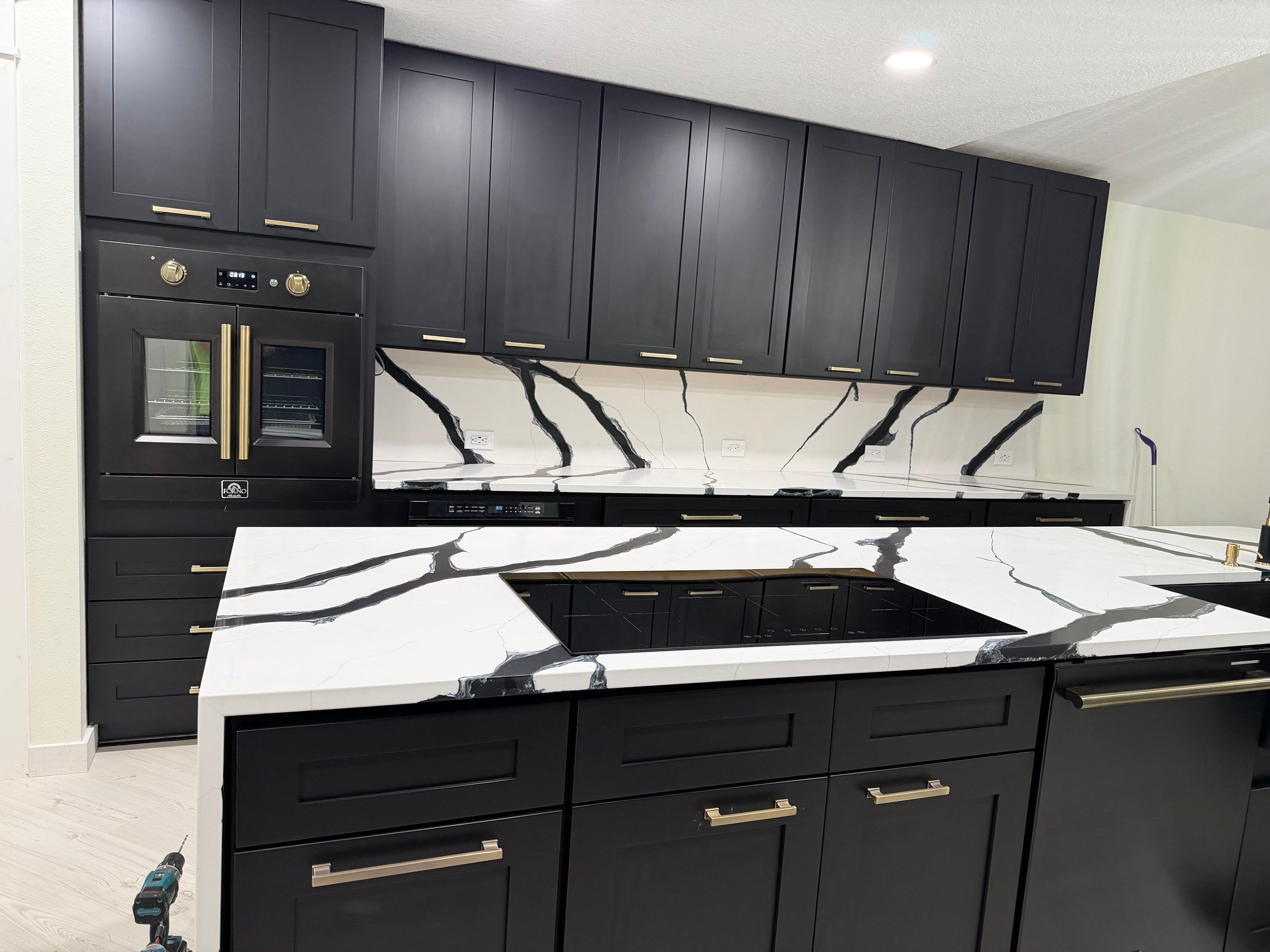 Modern Kitchen Remodel in Port Orange Featuring Waterfall Quartz Island by Acies Renovations