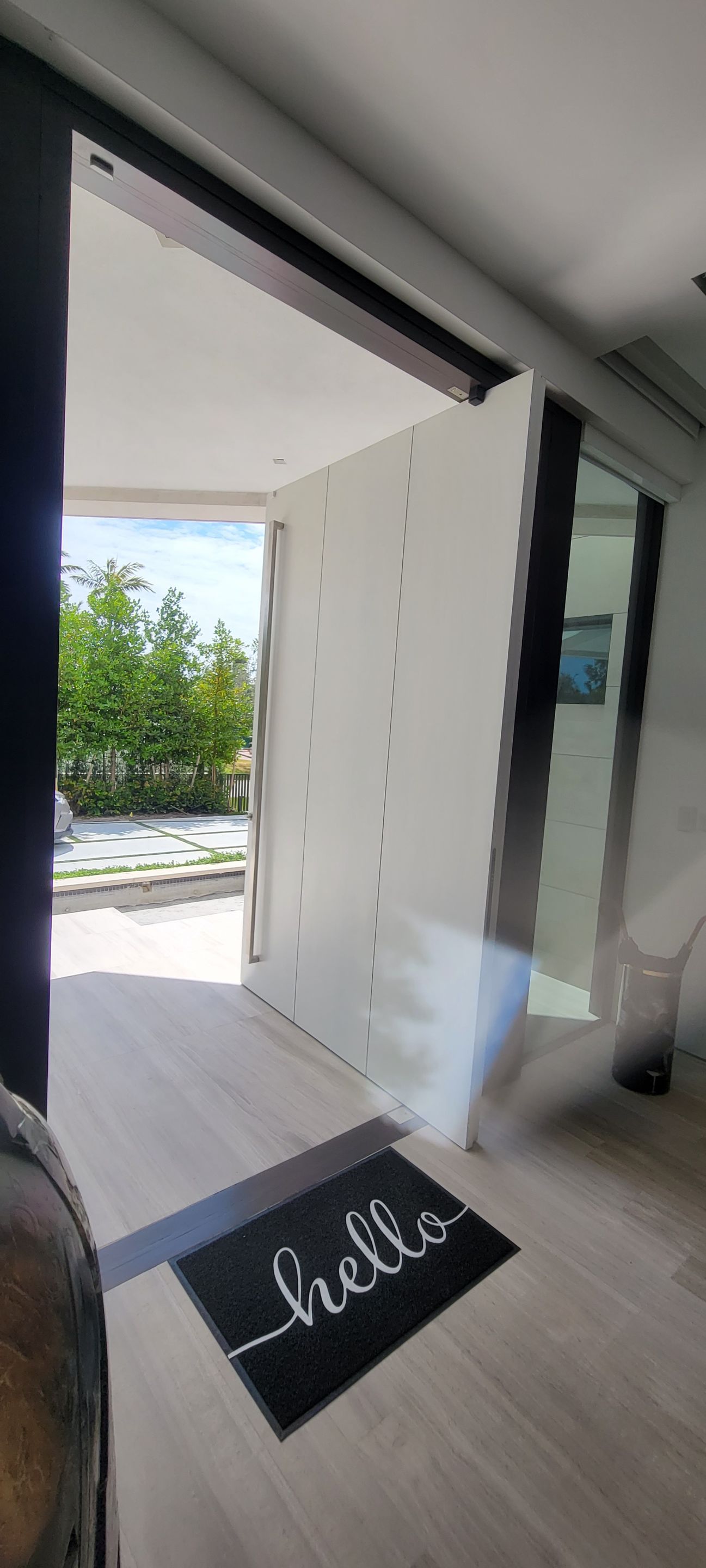 Custom Material Pivot Door installation by Impact Precious Wood Inc.