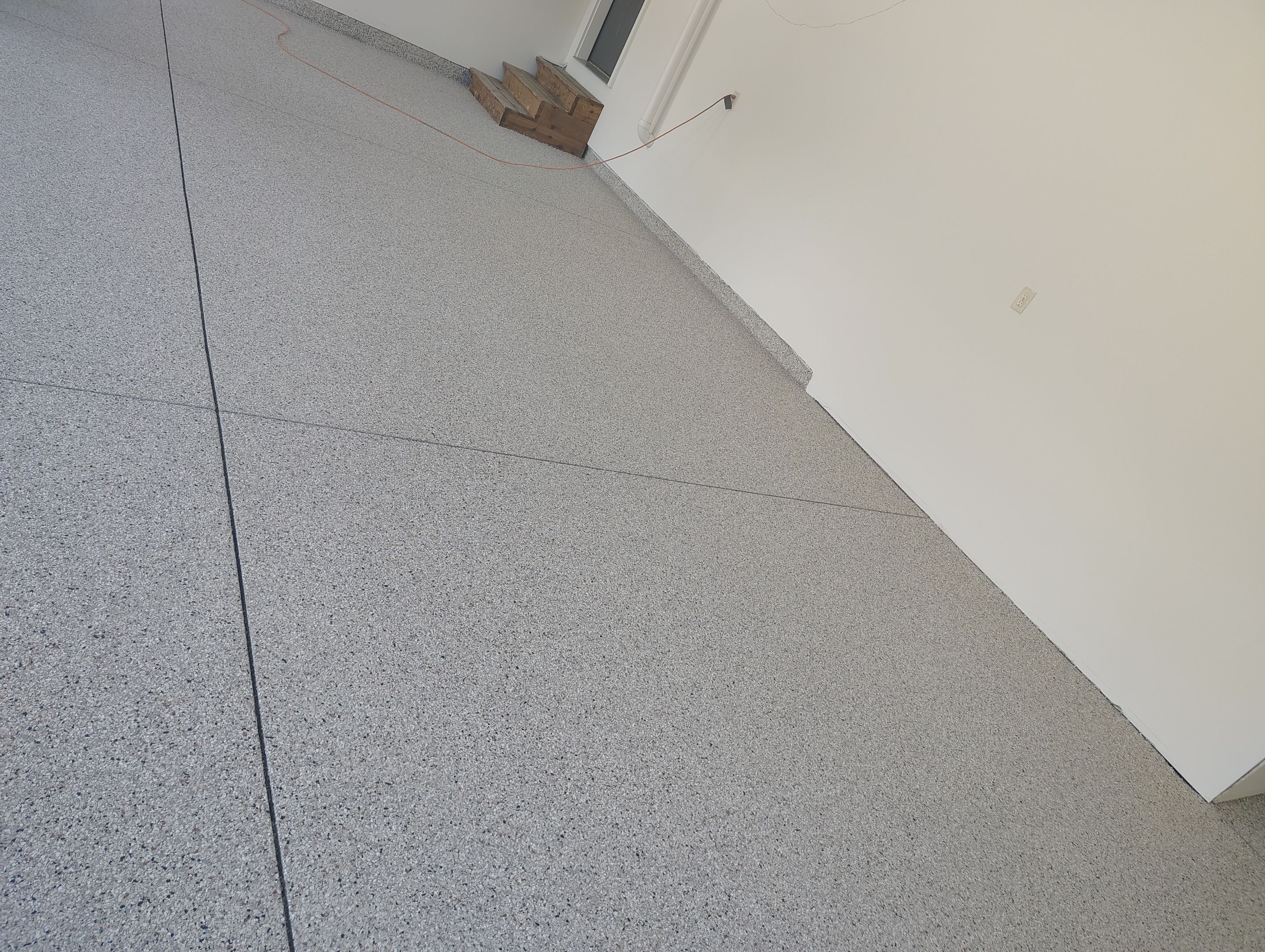 Custom Grey Speckled Epoxy Floor Coating for Sioux Falls Garage by Select Painting, Coatings & Garage Cabinets