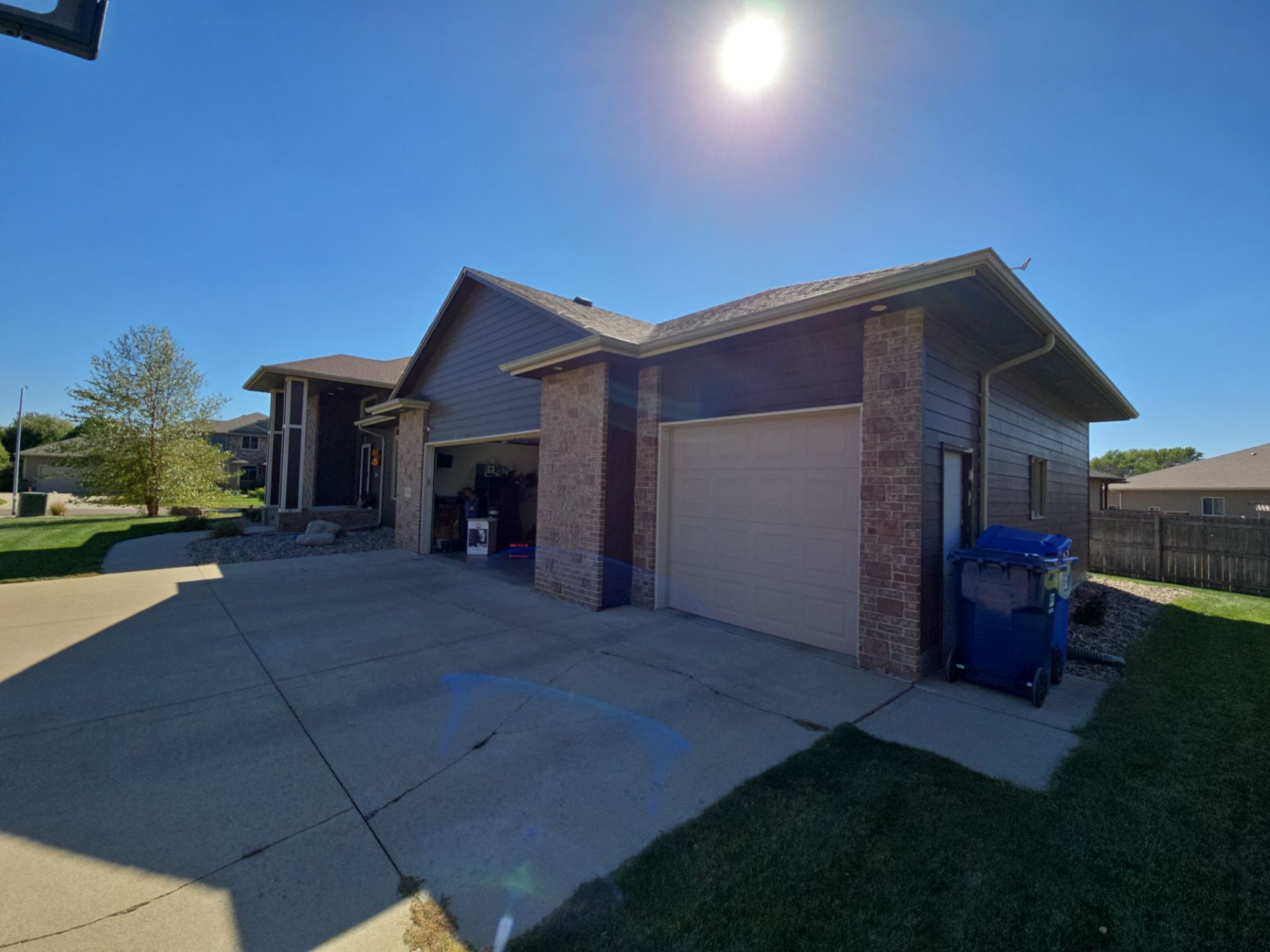 Dark Blue Exterior Home Painting and Siding Refresh in Sioux Falls by Select Painting, Coatings & Garage Cabinets