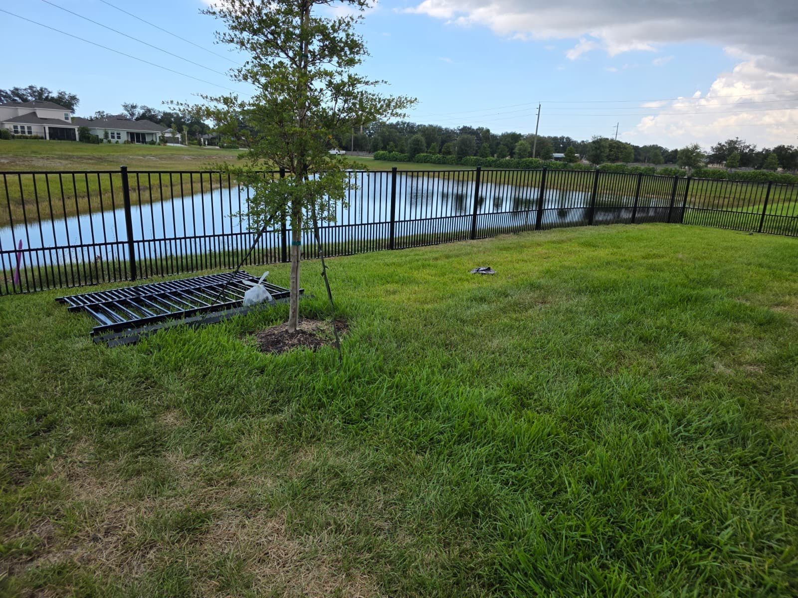 Black Aluminum Puppy Picket Fence Installation in Nokomis by True Fence LLC