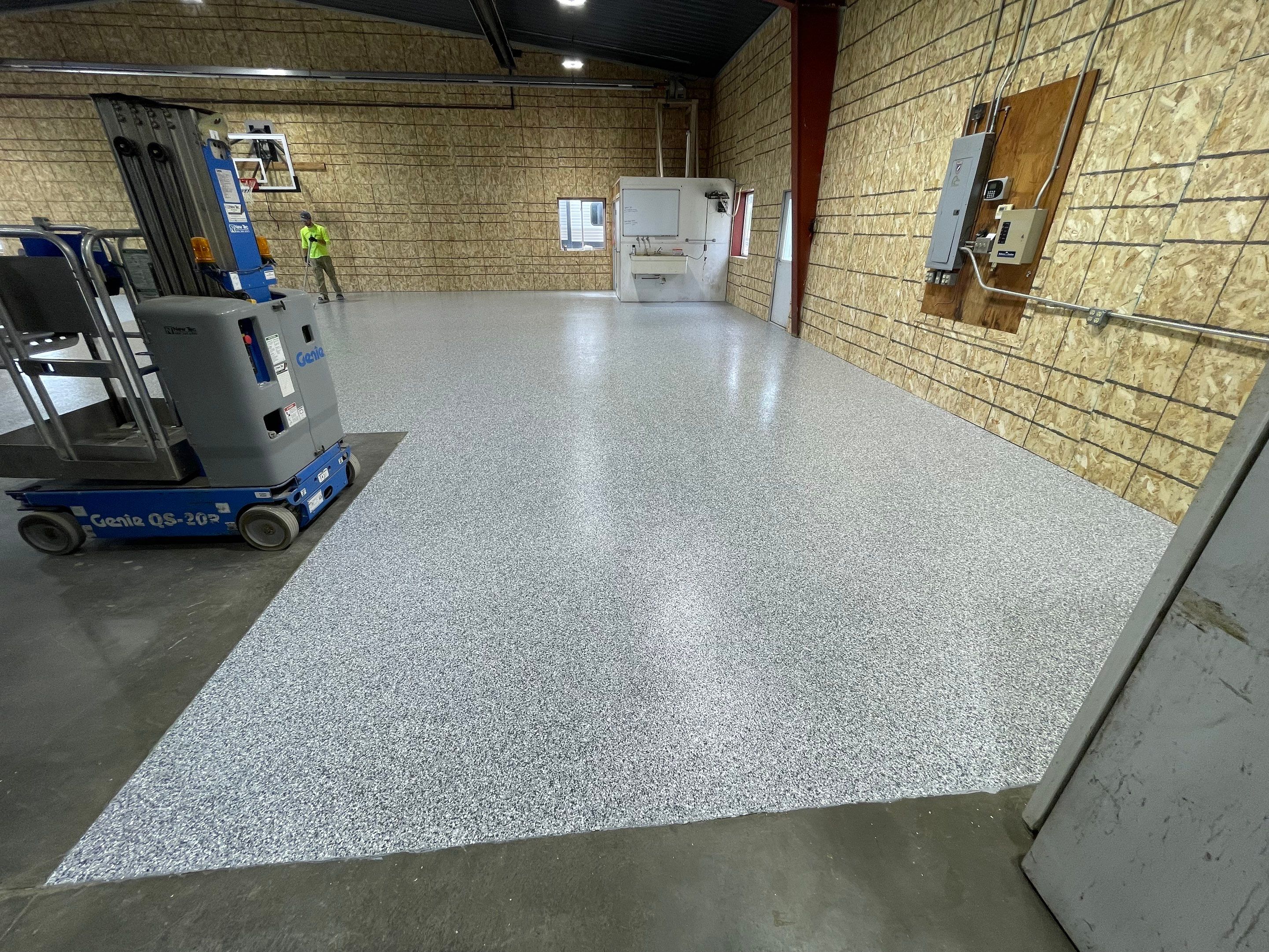 Custom Polyurea Shop Floor with Basketball Court Lines in Rock Valley by Select Painting, Coatings & Garage Cabinets