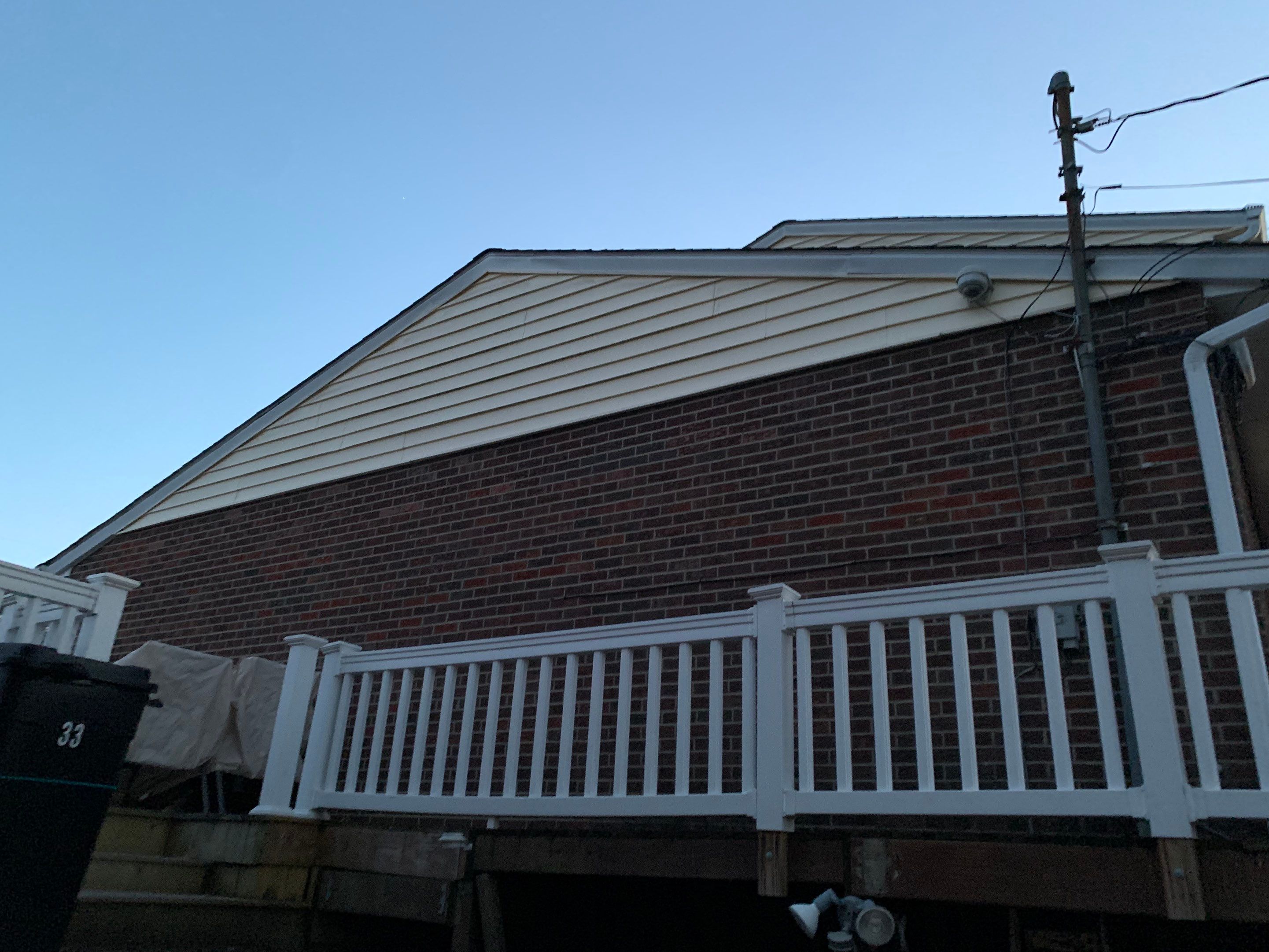 Replace dated vinyl siding with new white exterior Portfolio vinyl siding  by Secure Construction Company Inc