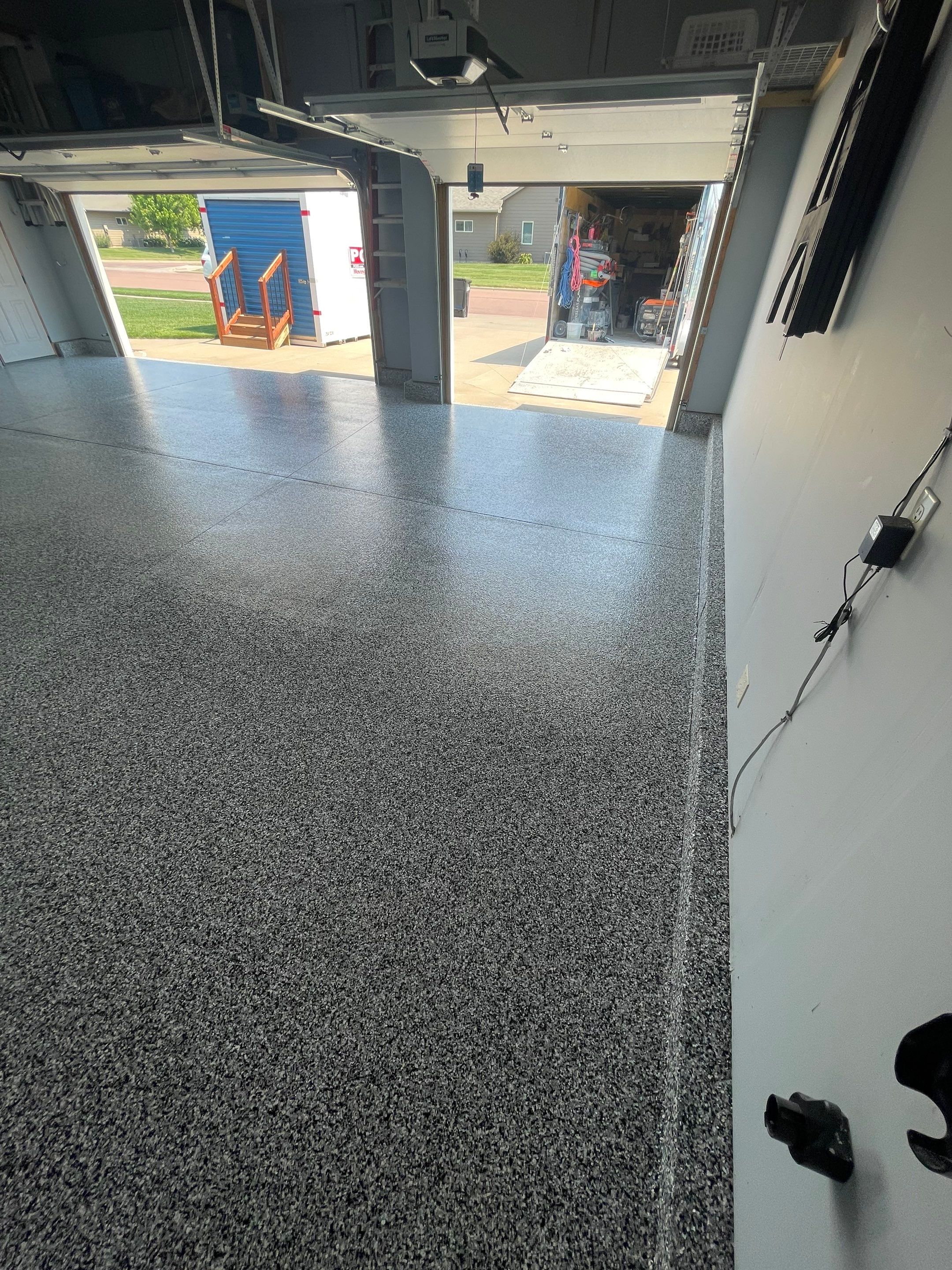 Sioux Falls Garage Concrete Coating Installation with Domino Flake by Select Painting, Coatings & Garage Cabinets