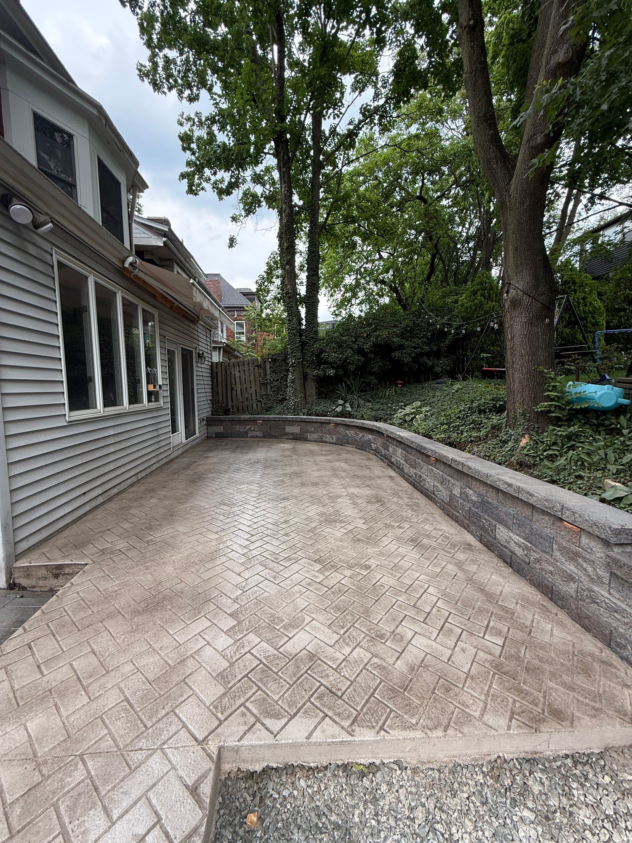 Stamped Concrete and Retaining Wall by Cousins Roofing Siding & Decks