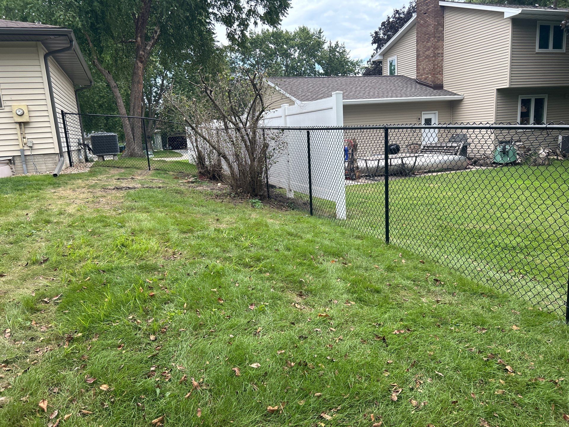 Black Vinyl-Coated Chain Link Fence Installation in Waterloo by Perfect Picket Fence and Stain