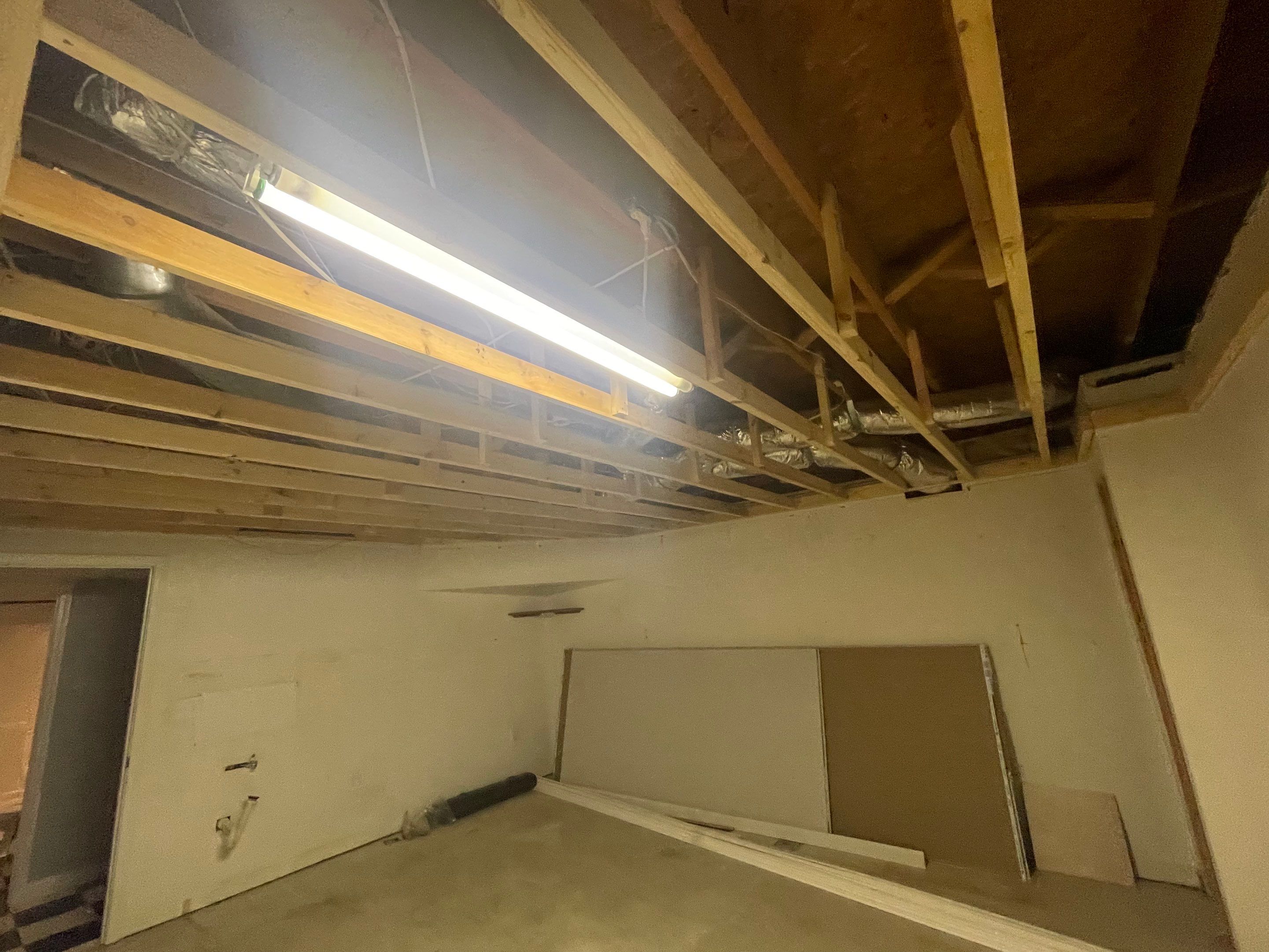 Finished Basement Room Transformation with Wood-Look Flooring in Roswell by Swift Home Renovations