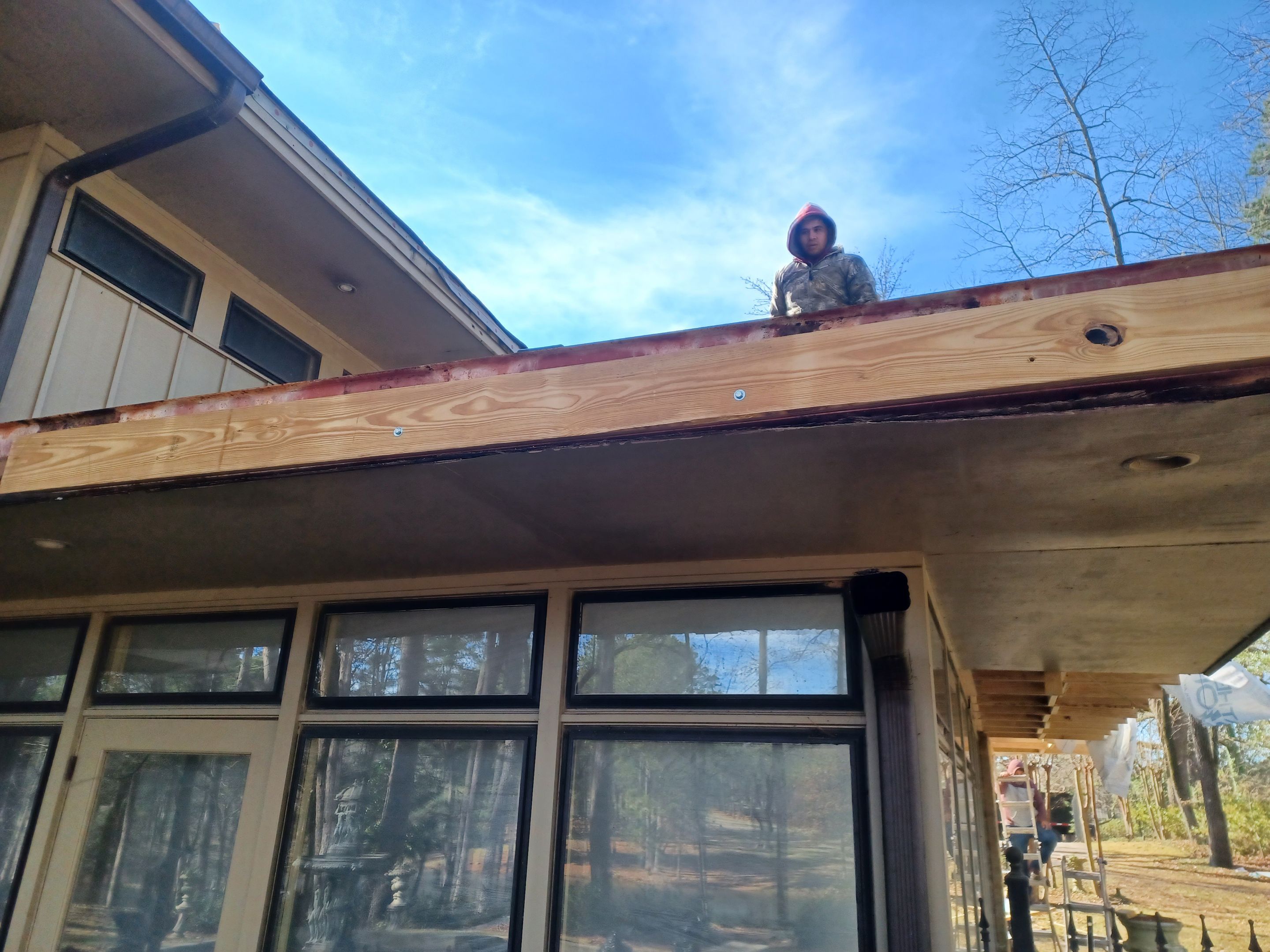 Residential Roofing Installation using PVC membrane and 24 gauge Standing Seam Metal by Hostetler Roofing