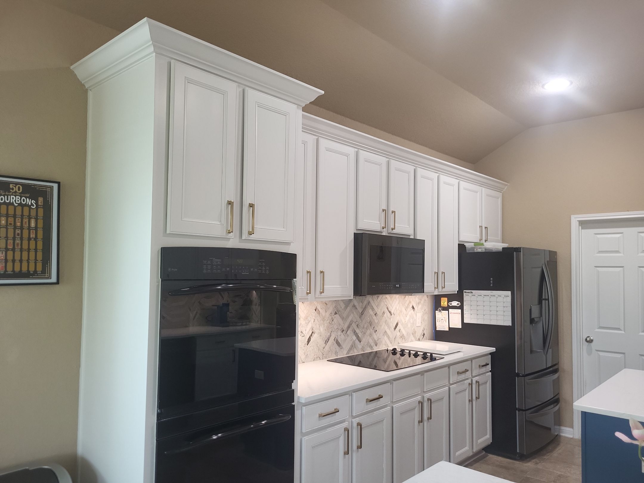 Cibolo Kitchen Refresh with Painted Cabinets, Quartz Countertops & Herringbone Backsplash by Legacy Bath and Kitchen