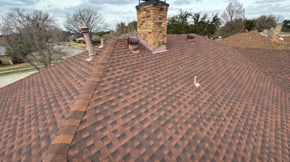 Medium brown brick with Tamko Rustic Cedar by Tejas Roofworks + Restoration