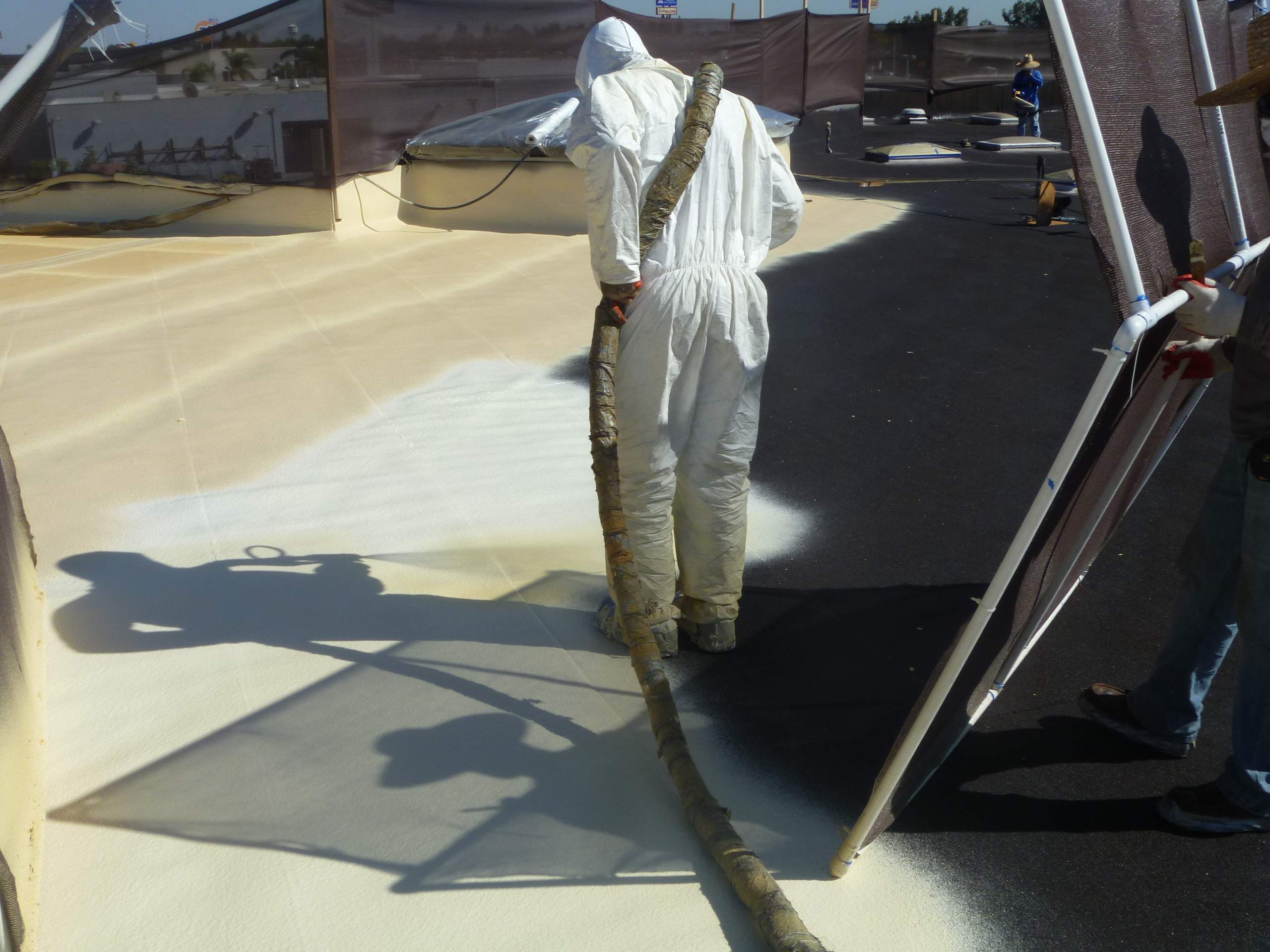 Commercial Roofing Installation using Spray foam and Conklin Benchmark/PUMA XL 18 yr warranty coatings by Straight Edge Roofing Inc