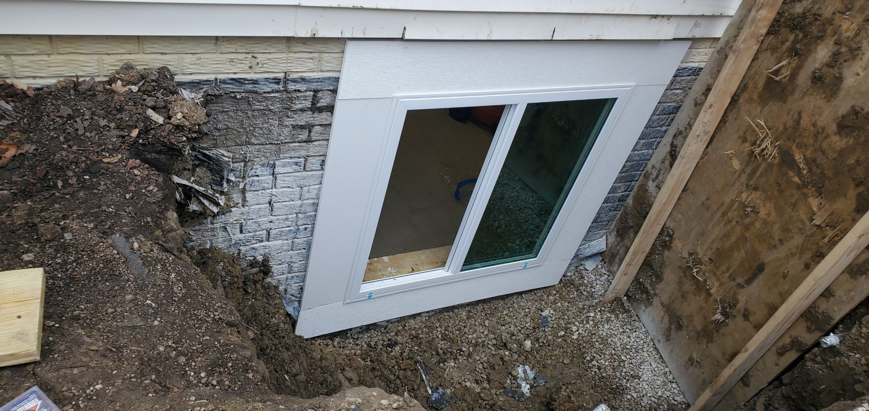 Egress Window Installation using Rockwell Egress Fiberglass Egress Window Well by Toledo Basement Repair 