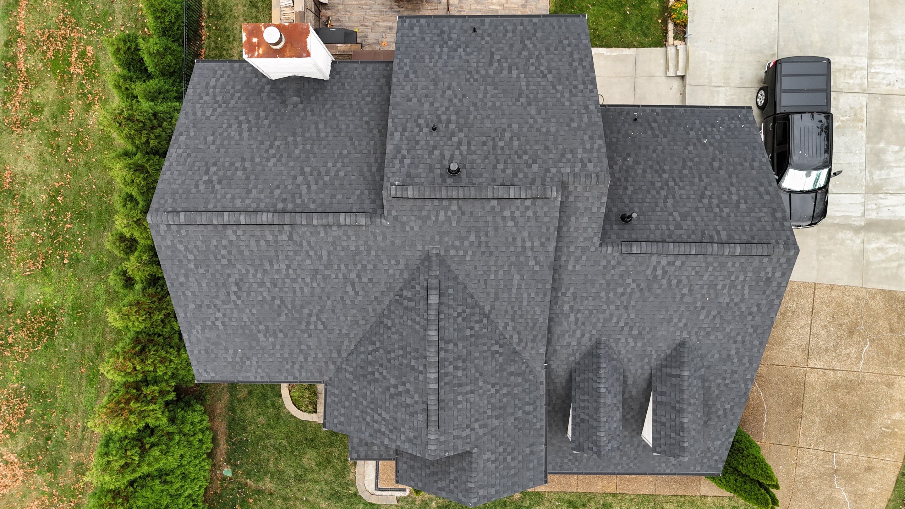 Charcoal Black Re-Roof & Gutters by Royal House LLC