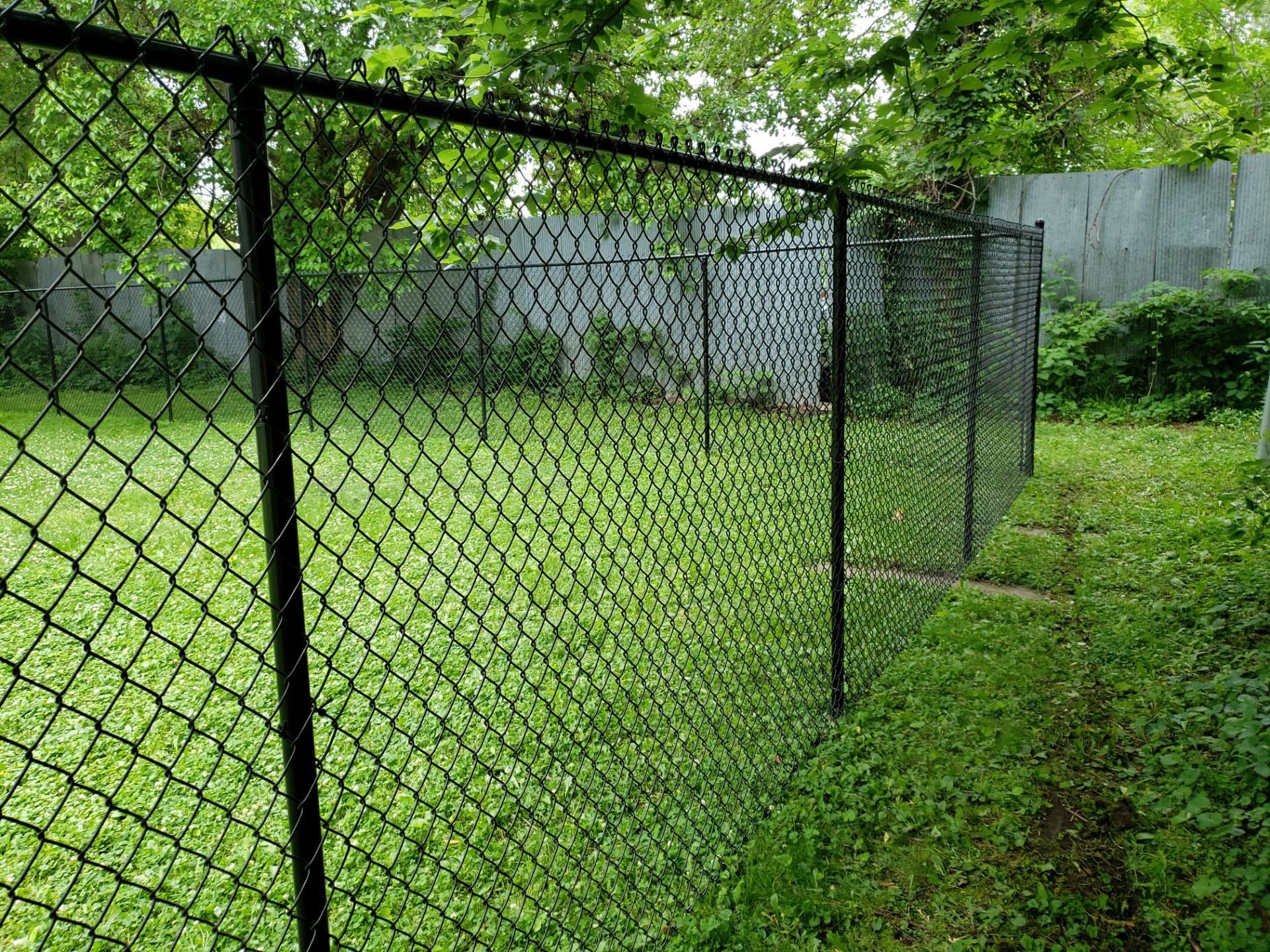 Black Vinyl Chain Link Fence Installation in Charles City by Perfect Picket Fence and Stain