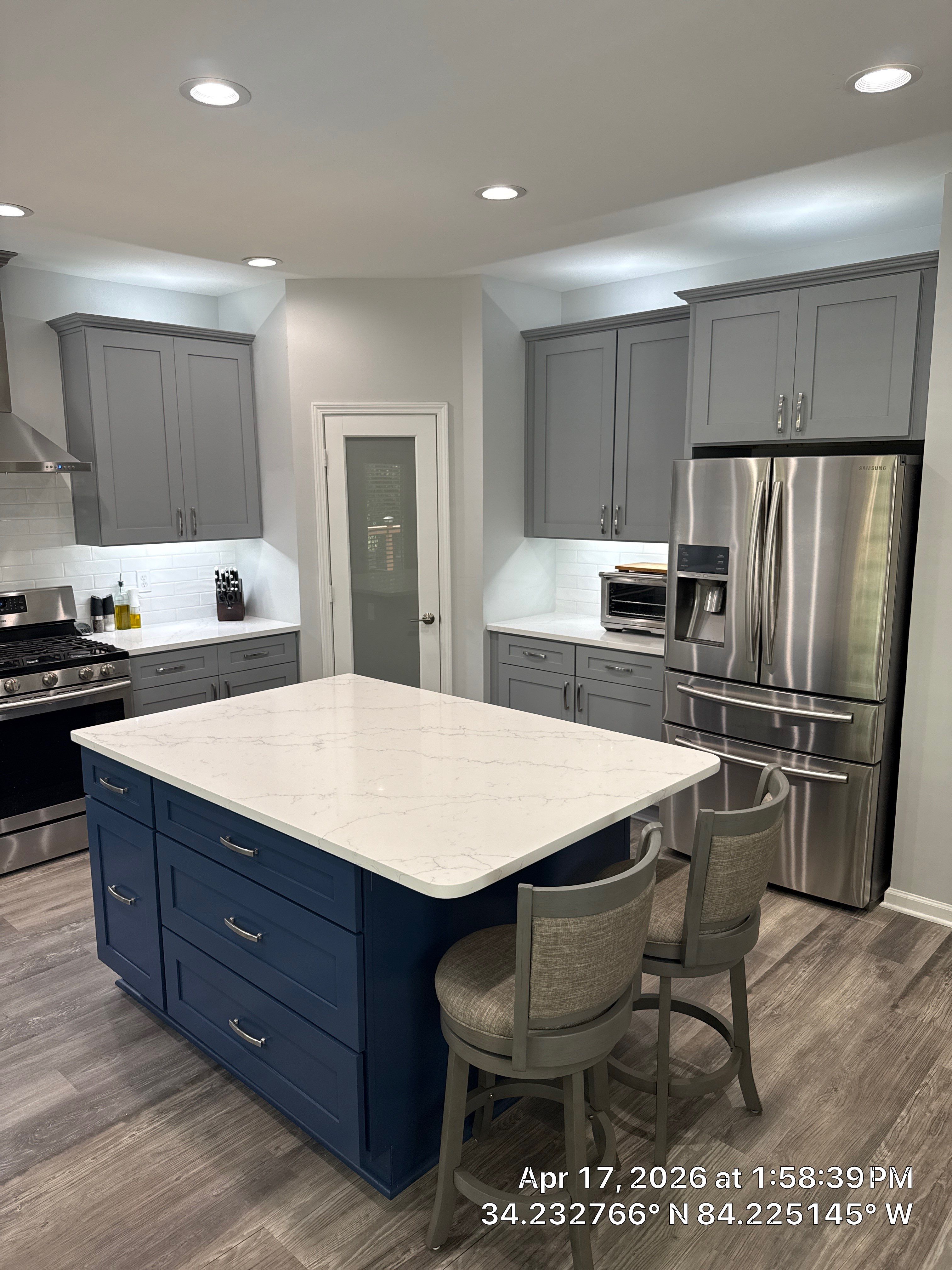 Modern Kitchen Remodel With Grey Shaker Cabinets and Navy Blue Island by Heart & Home Kitchen & Bath Remodeling LLC