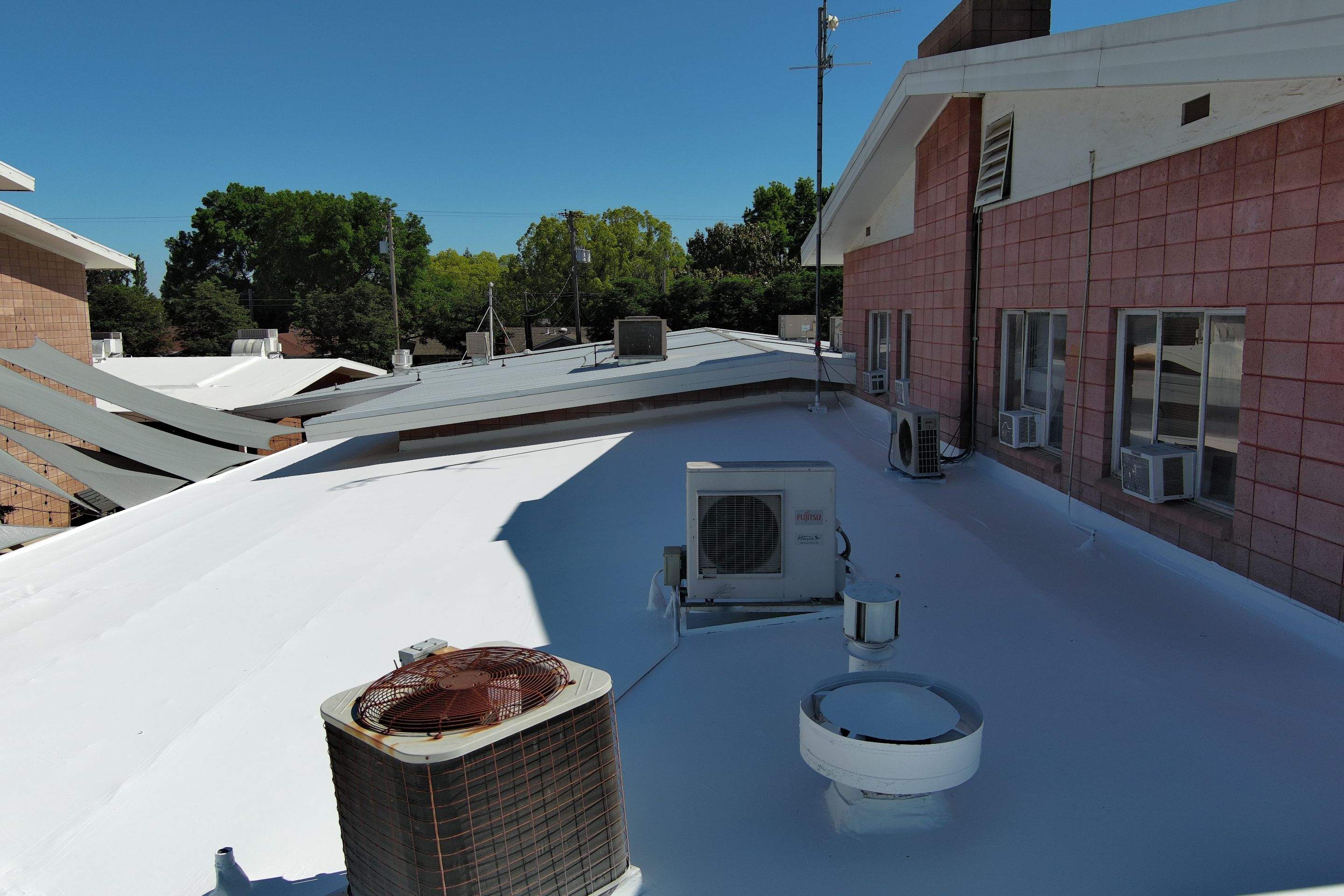 Single-ply restoration system using Benchmark/PUMA XL coatings over TPO single-ply roofing by Straight Edge Roofing Inc