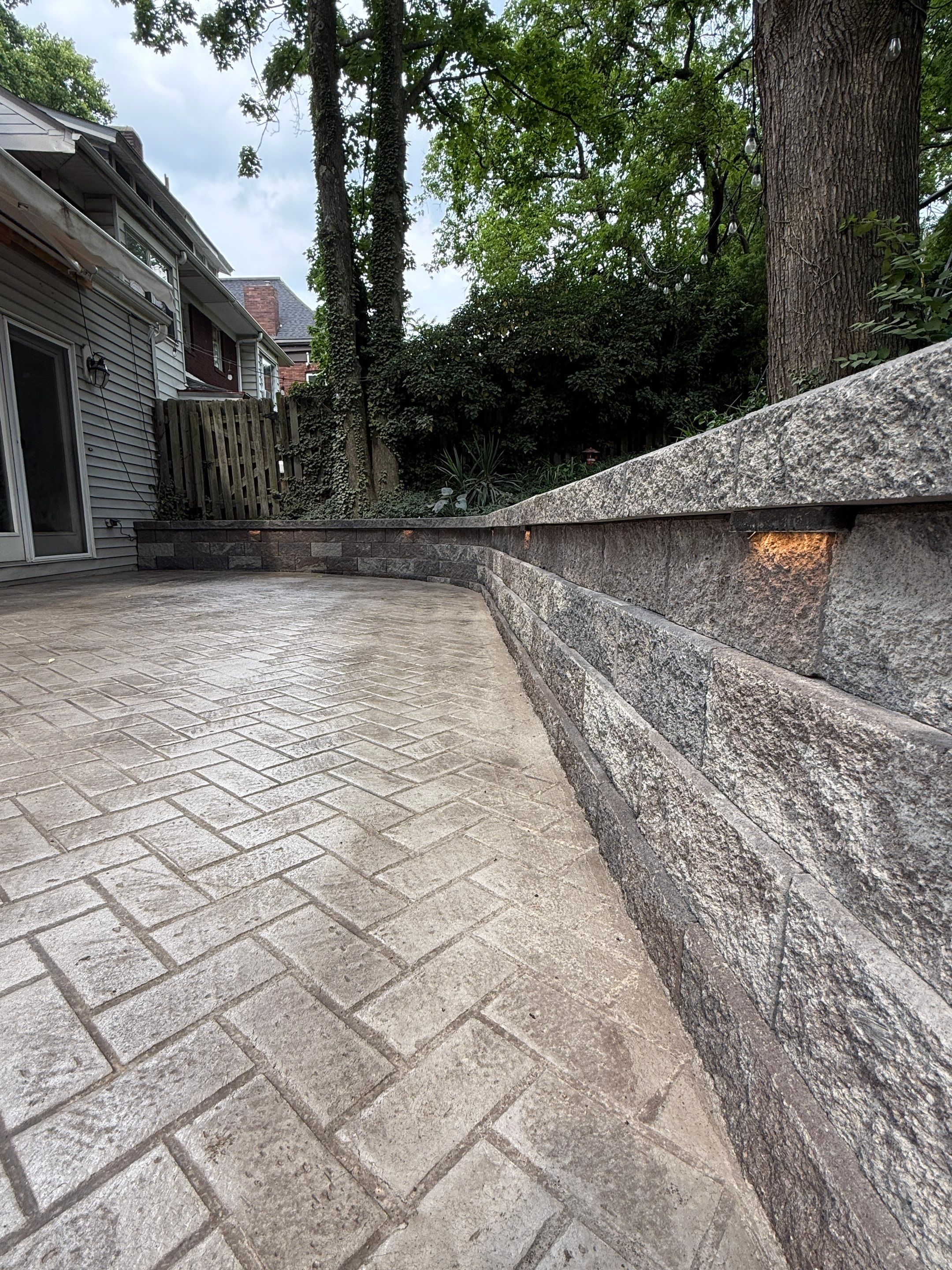 Stamped Concrete and Retaining Wall by Cousins Roofing Siding & Decks