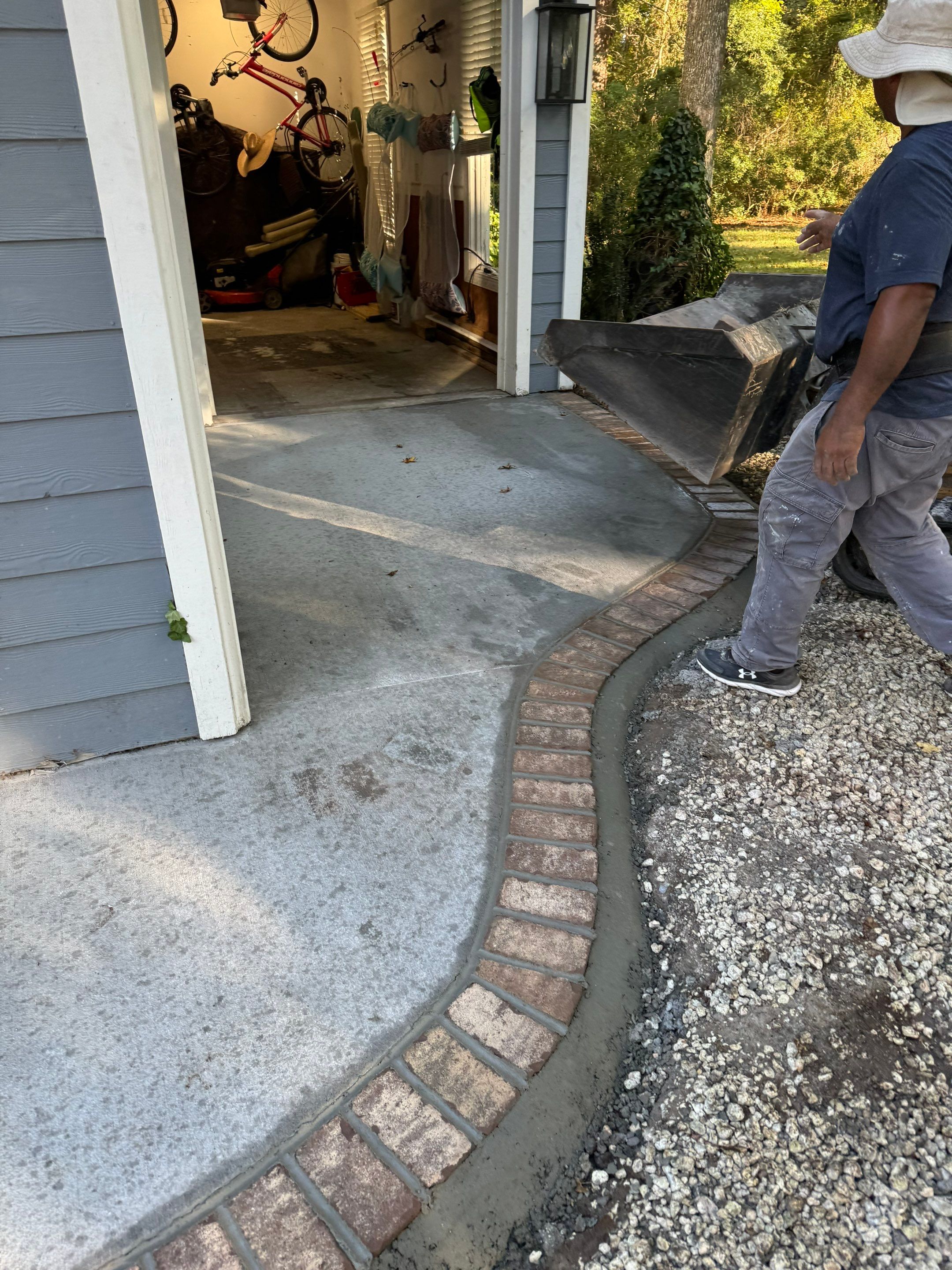 Concrete Driveway and Patio Installation With Decorative Brick Borders by Lowcountry Scapes, LLC