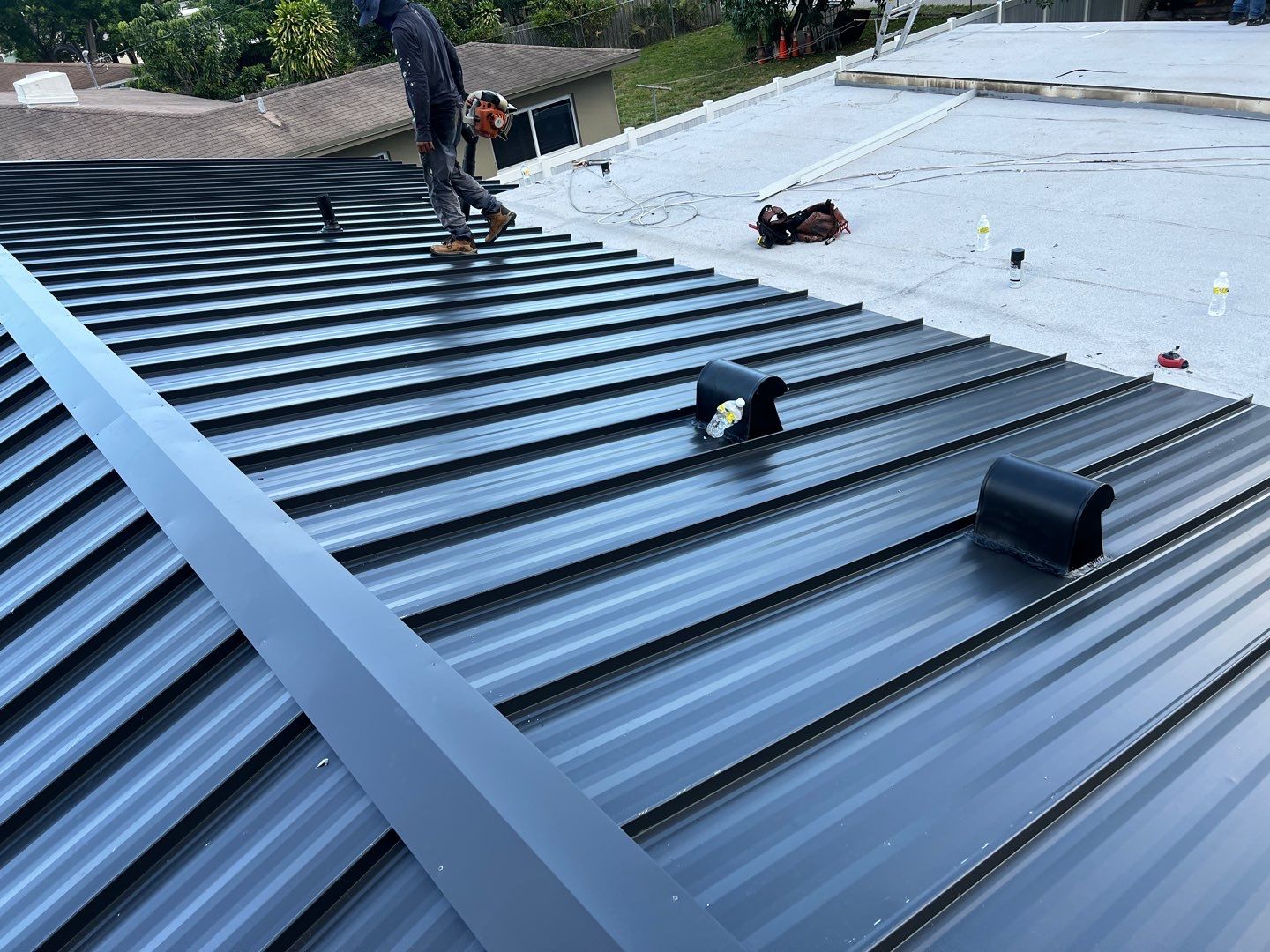 Standing Seam Metal & Flat Re-Roof using 1.5" Nail Strip 24ga Black Matte Kynar Coated Standing Seam Metal Panels by Morton Roofing, Inc.