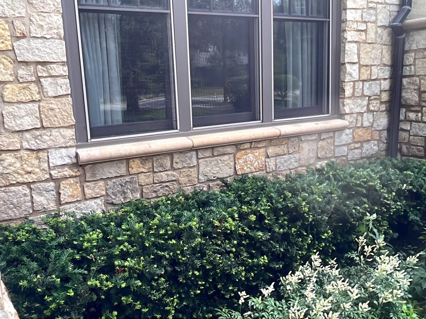Northbrook, IL stucco home soft wash and stone cleaning by Northern Power Washing LLC.