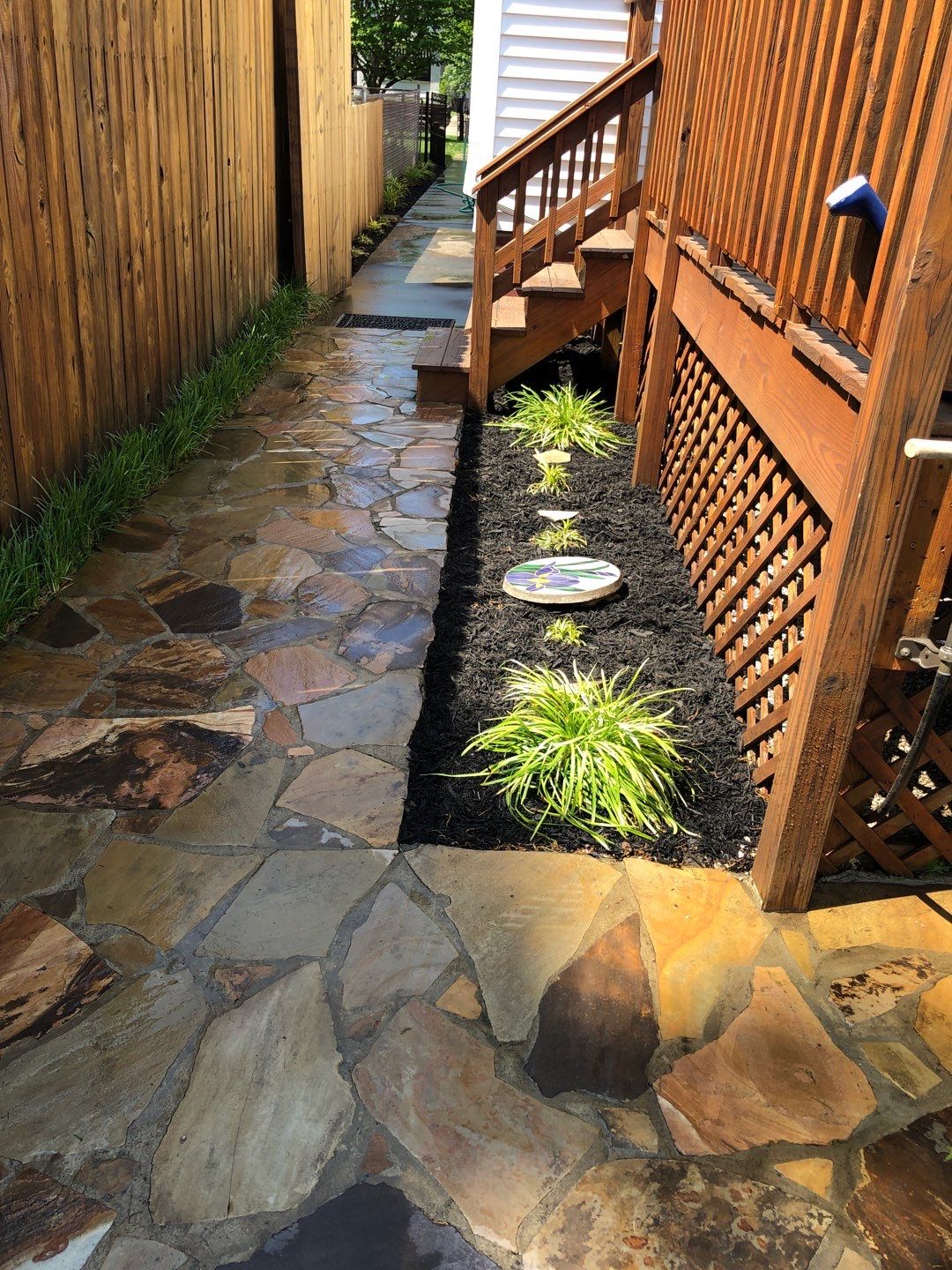 Liriope grasses, mulch and stone pavers by GrassBusters, Inc.
