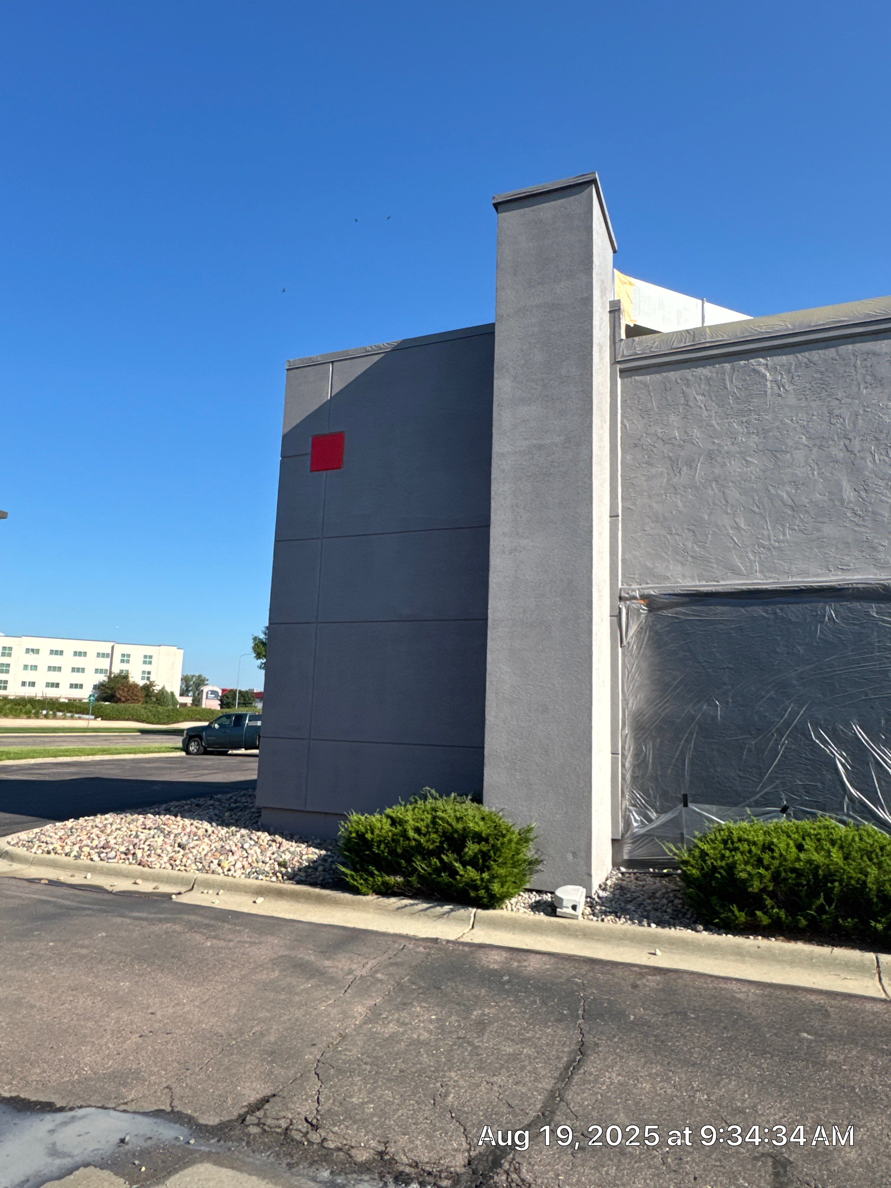 Commercial Exterior Painting with Stucco and Bold Red Accent Trim by Select Painting, Coatings & Garage Cabinets
